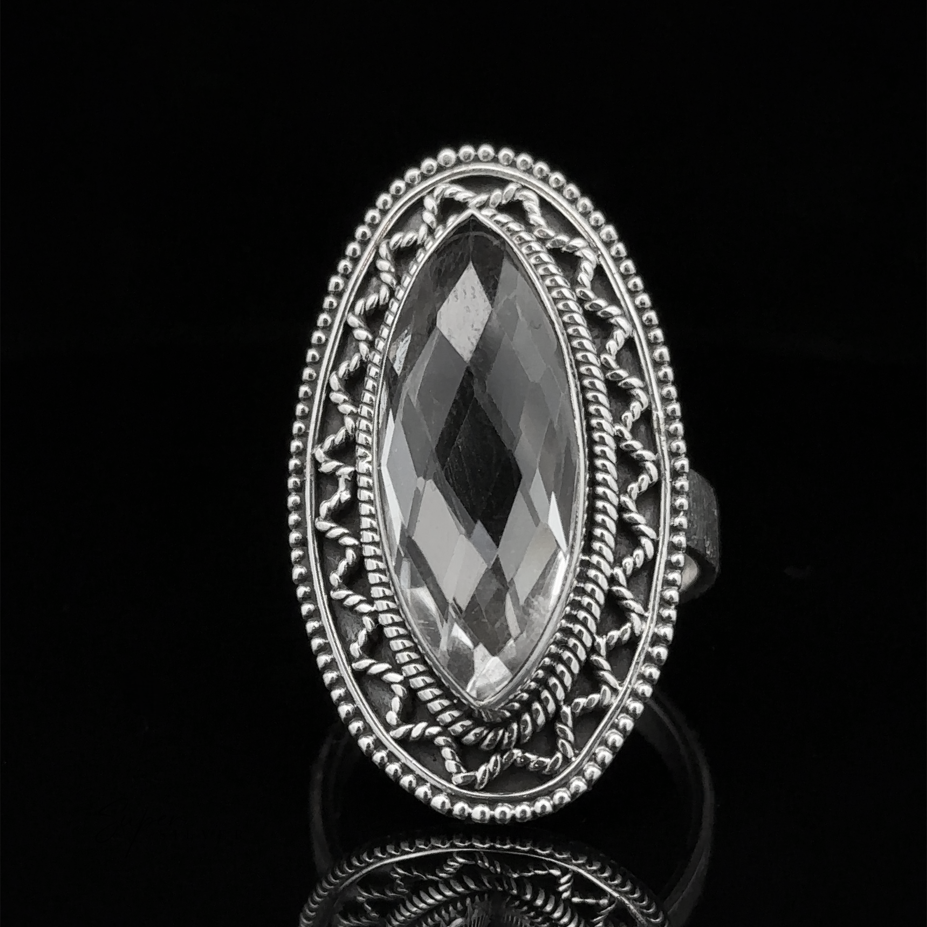 Marquise Shaped Gemstone Ring With Vintage Shield Border in an ornate Sterling Silver setting on a black background, giving it a Bohemian twist.