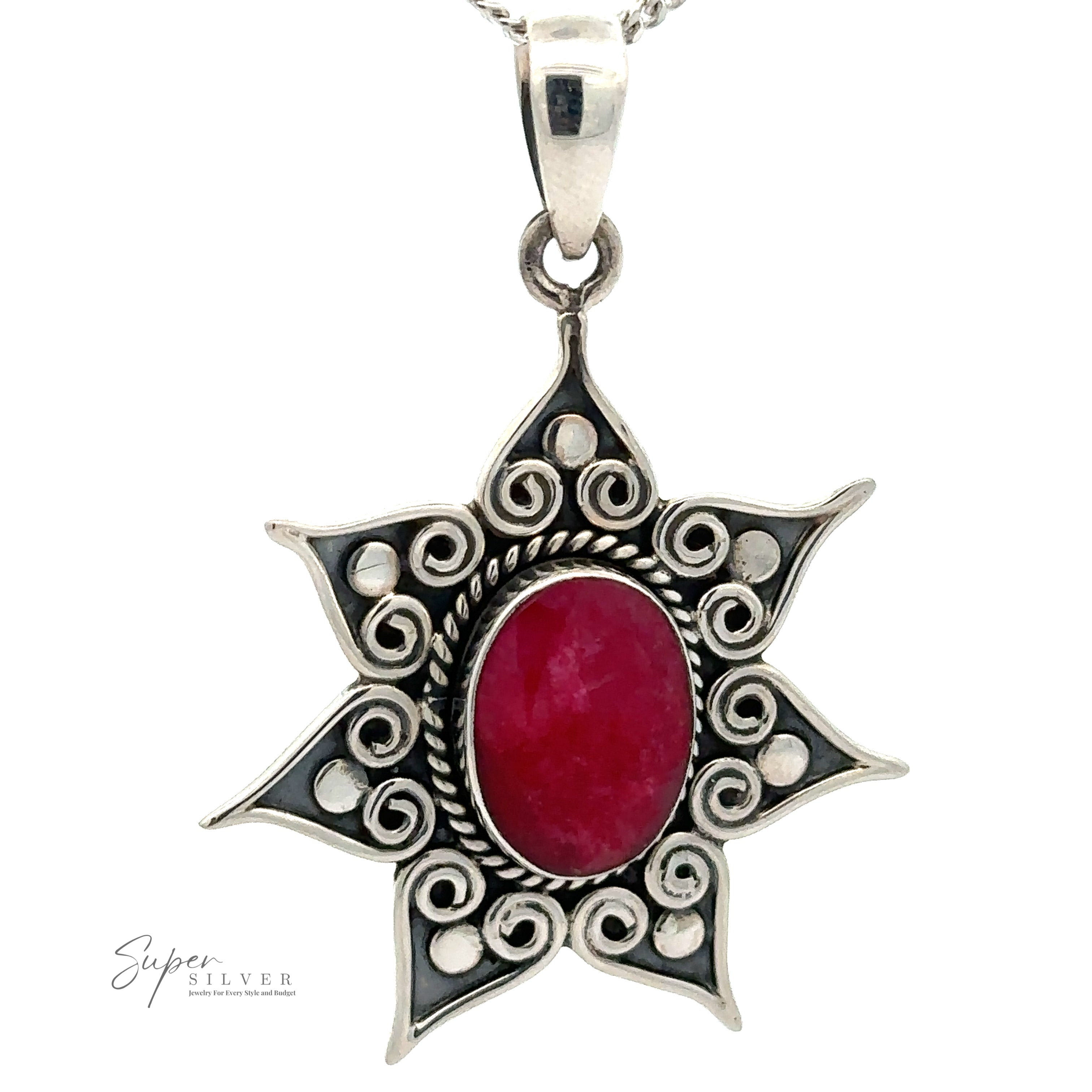 A Floral Design Gemstone Pendant with a red oval gemstone in the center, surrounded by intricate swirl patterns forming a star-like design. The pendant is on a silver chain.
