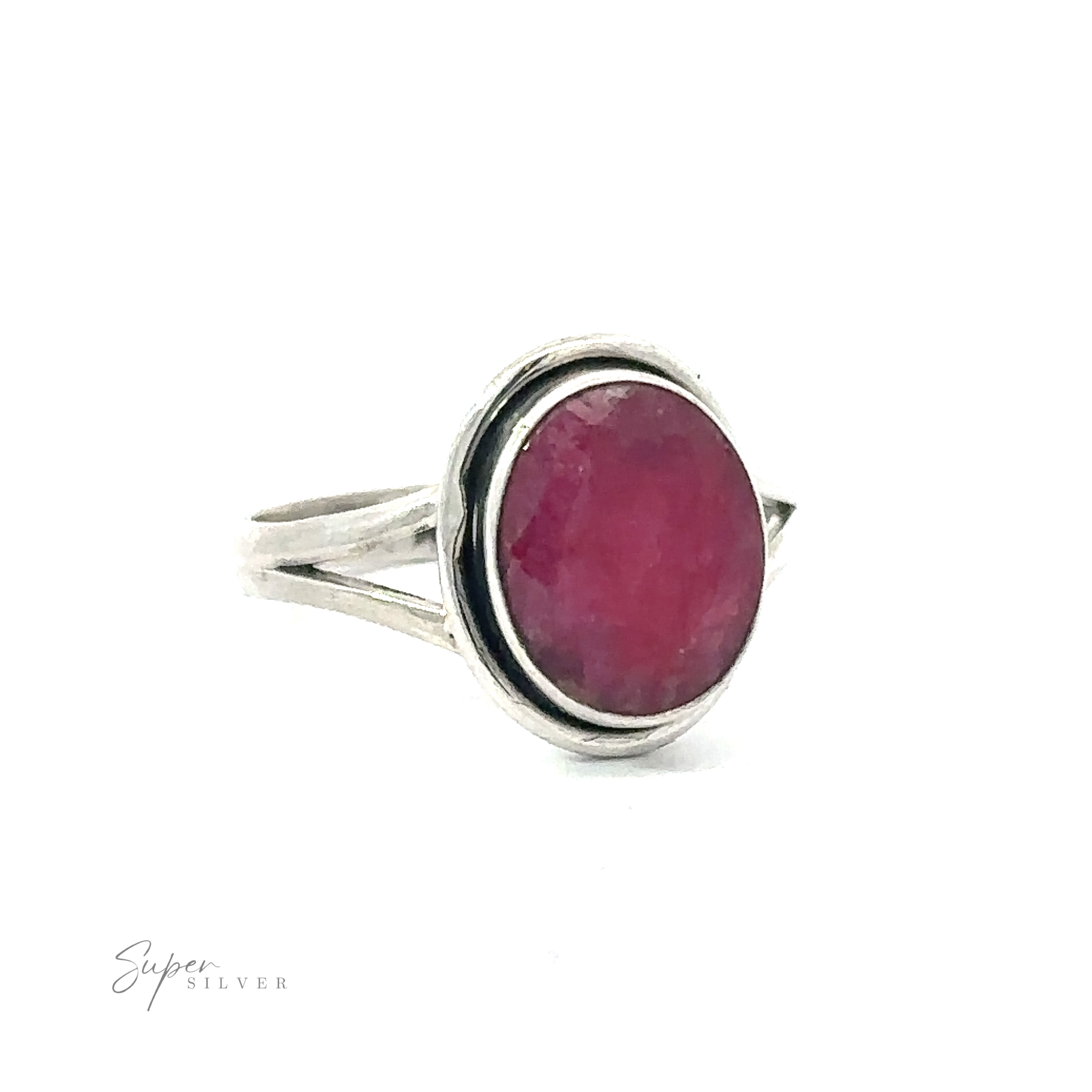 Oval split shank stone ring with a pink gemstone on a white background.