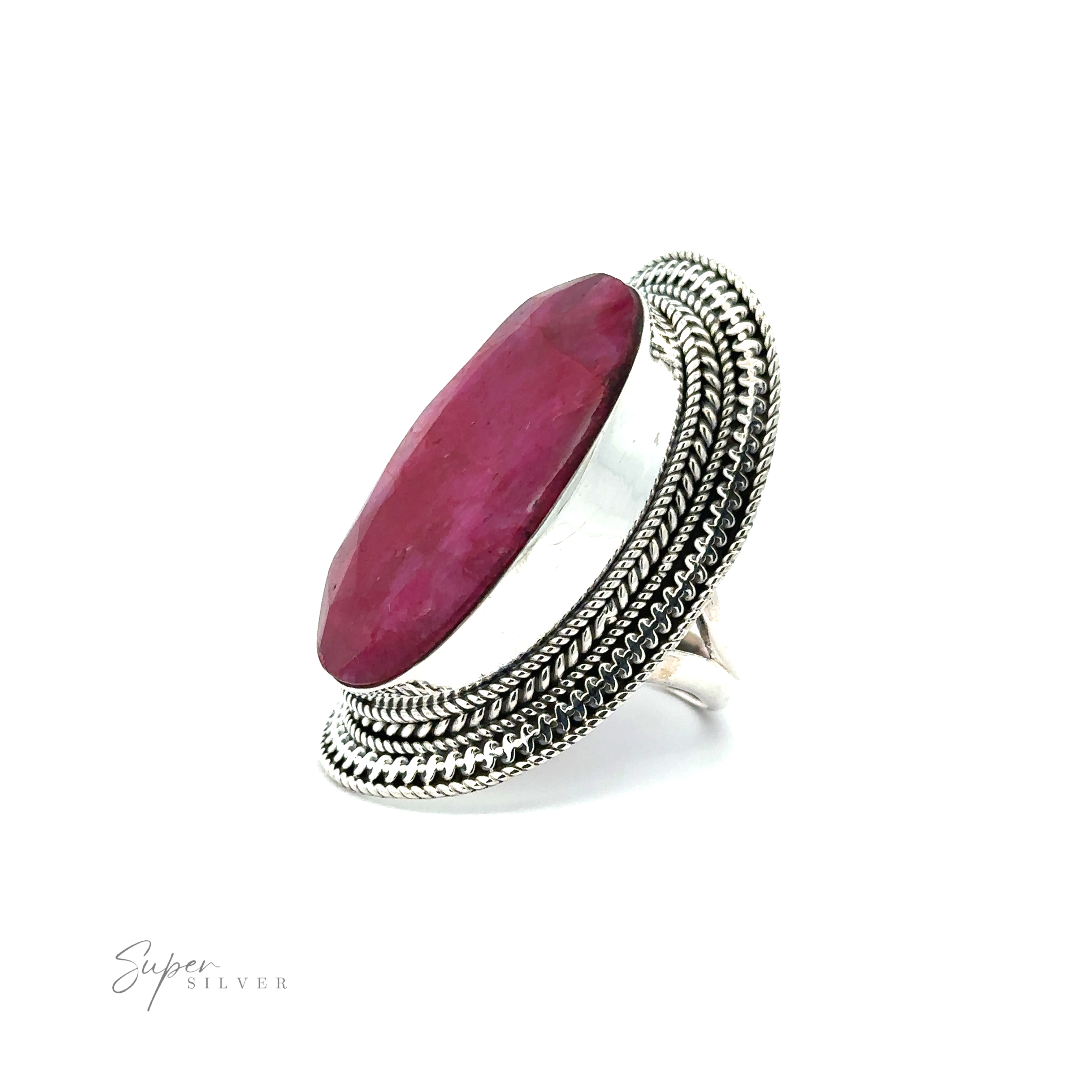 A Large Oval Shield Gemstone Ring features a large, oval-shaped purple stone with intricate detailing on the band, exuding a touch of bohemian flair. The background is white.