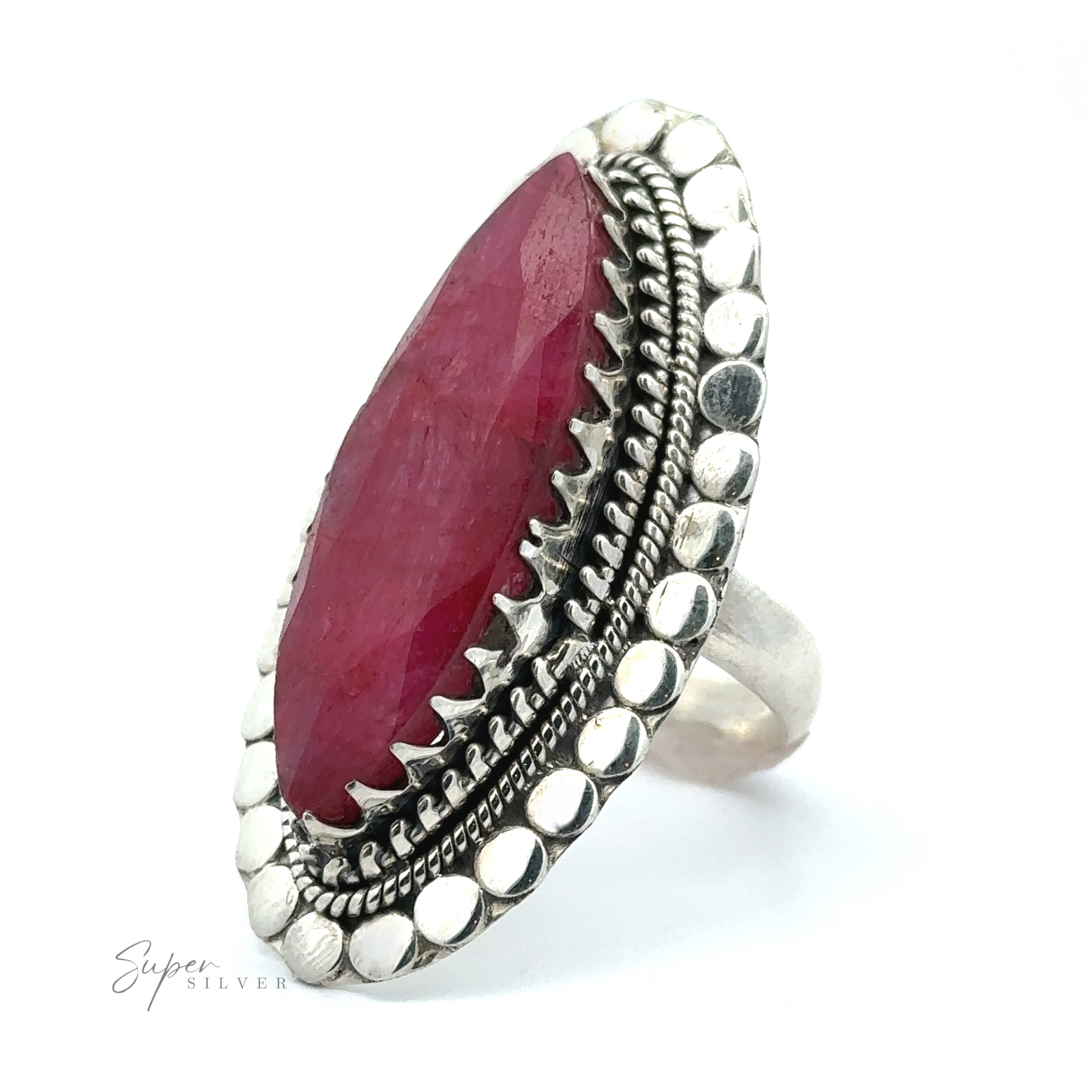 A Statement Marquise Shaped Gemstone Ring featuring a marquise-shaped pink gemstone set within an ornate, textured bezel, exemplifying bohemian jewelry charm.