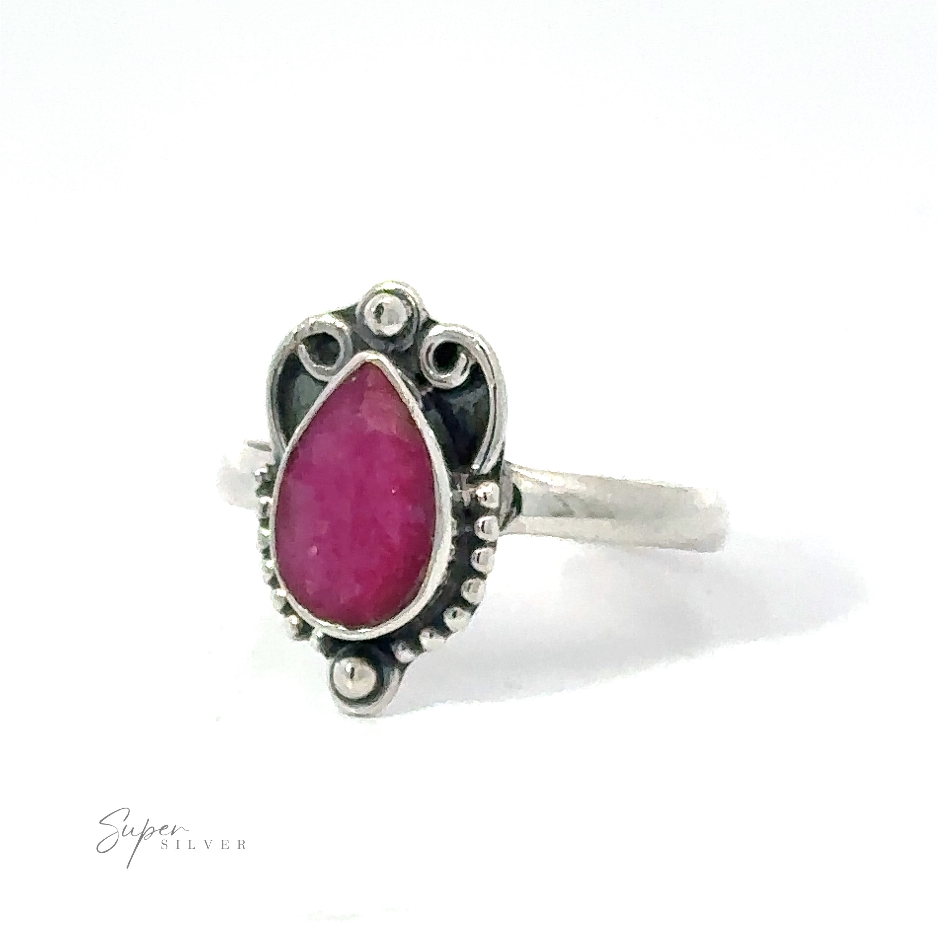 Vintage Inspired Teardrop Gemstone Ring featuring a pear-shaped pink stone set in an ornate bezel, displayed against a white background. This .925 Sterling Silver piece adds a boho vibe to any look.