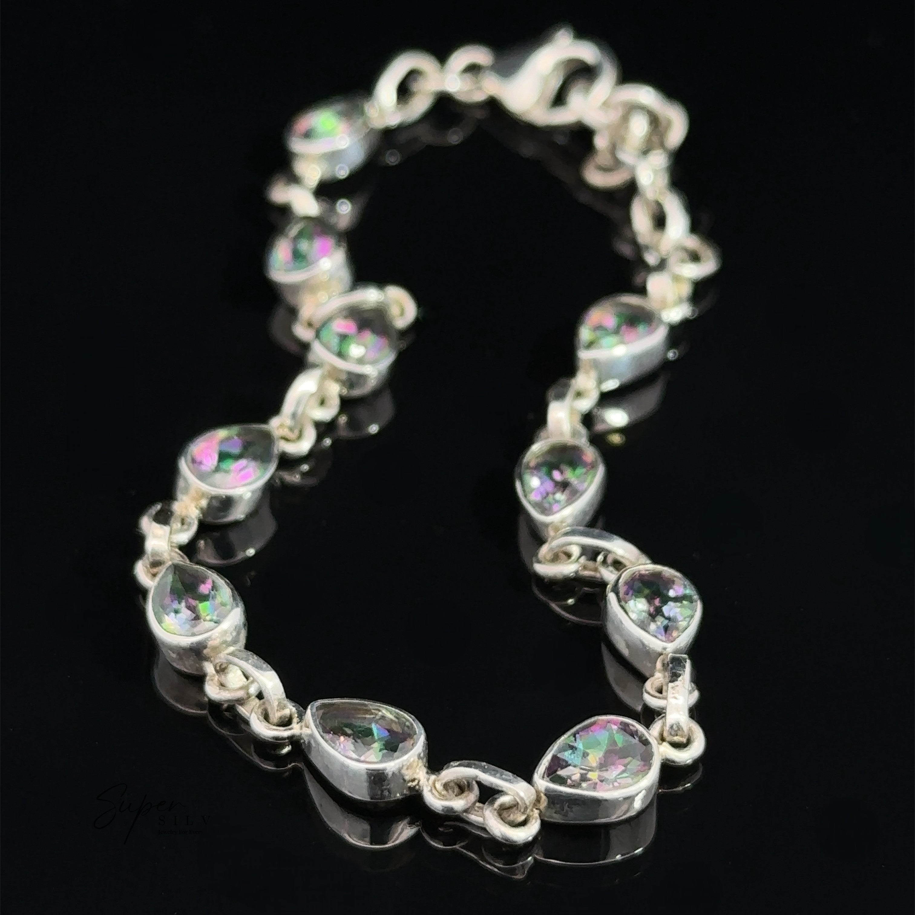 A Rainbow Mystic Topaz Teardrop Shape Link Bracelet, displayed on a black surface.