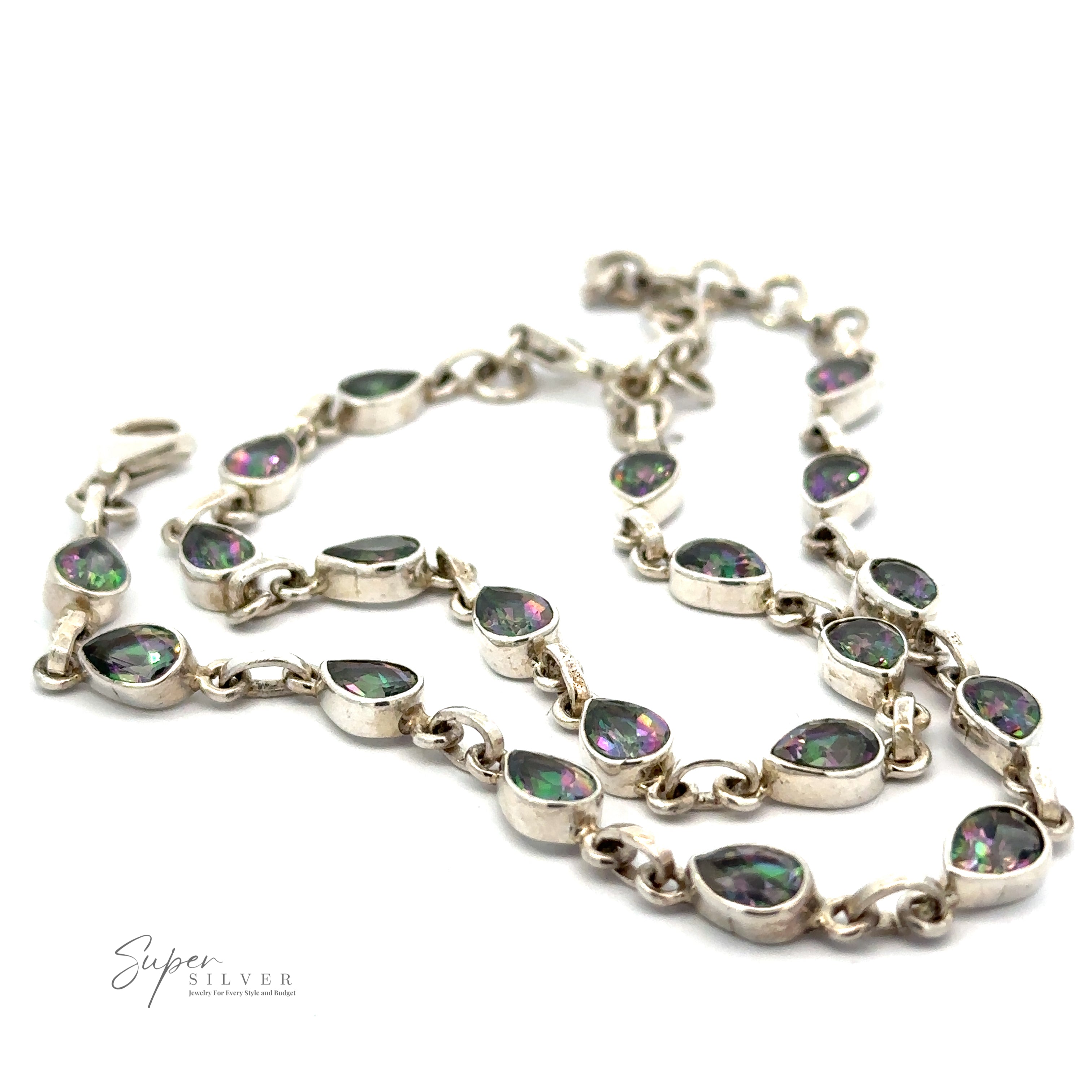 Silver necklace with teardrop-shaped, iridescent gemstones. "Super Silver" logo in the bottom left corner. Also, explore our stunning Rainbow Mystic Topaz Teardrop Shape Link Bracelet collection for matching elegance.