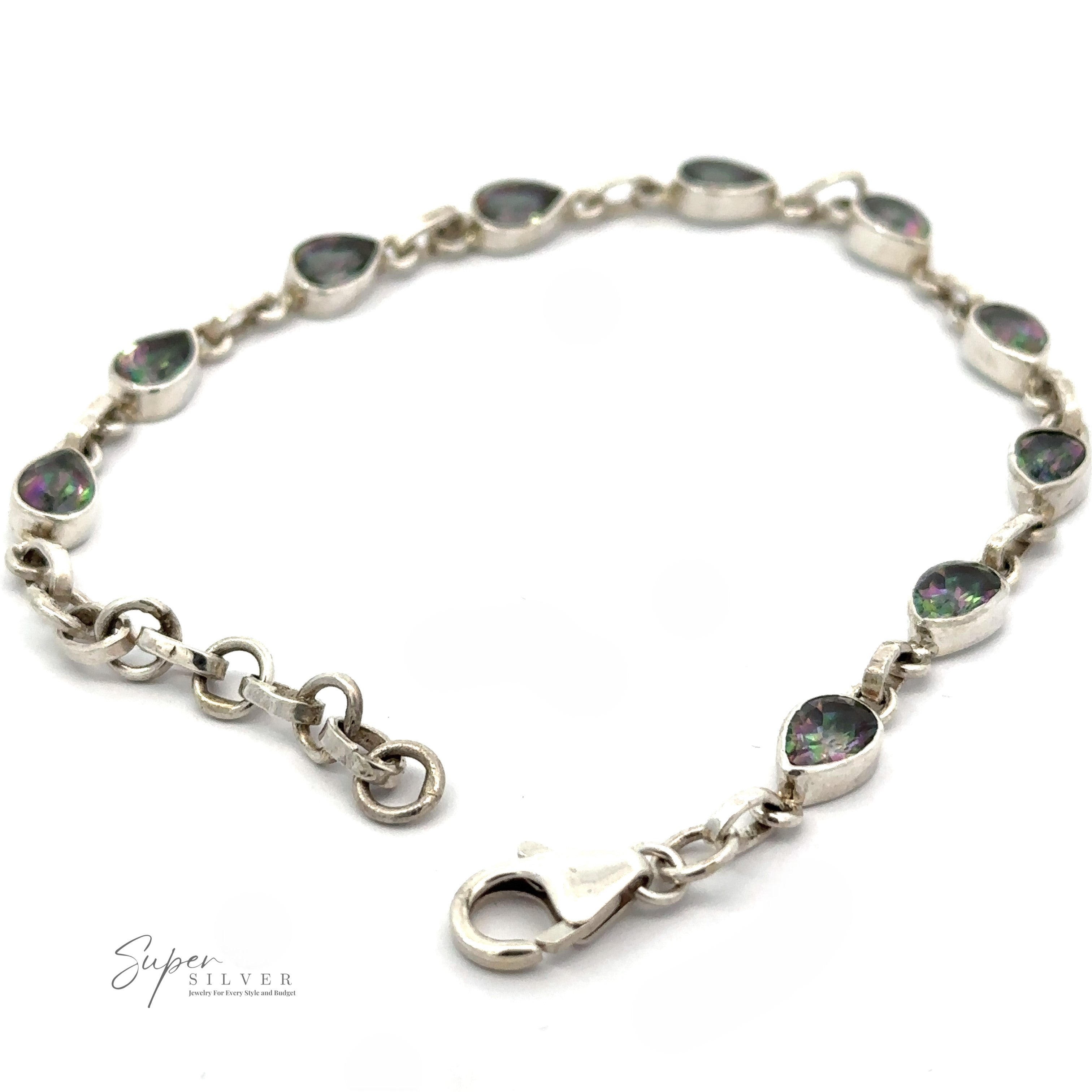 A silver bracelet adorned with teardrop-shaped gemstones and a lobster clasp lies on a white background. A "Super Silver" logo is visible at the bottom left corner, showcasing this exquisite Rainbow Mystic Topaz Teardrop Shape Link Bracelet.