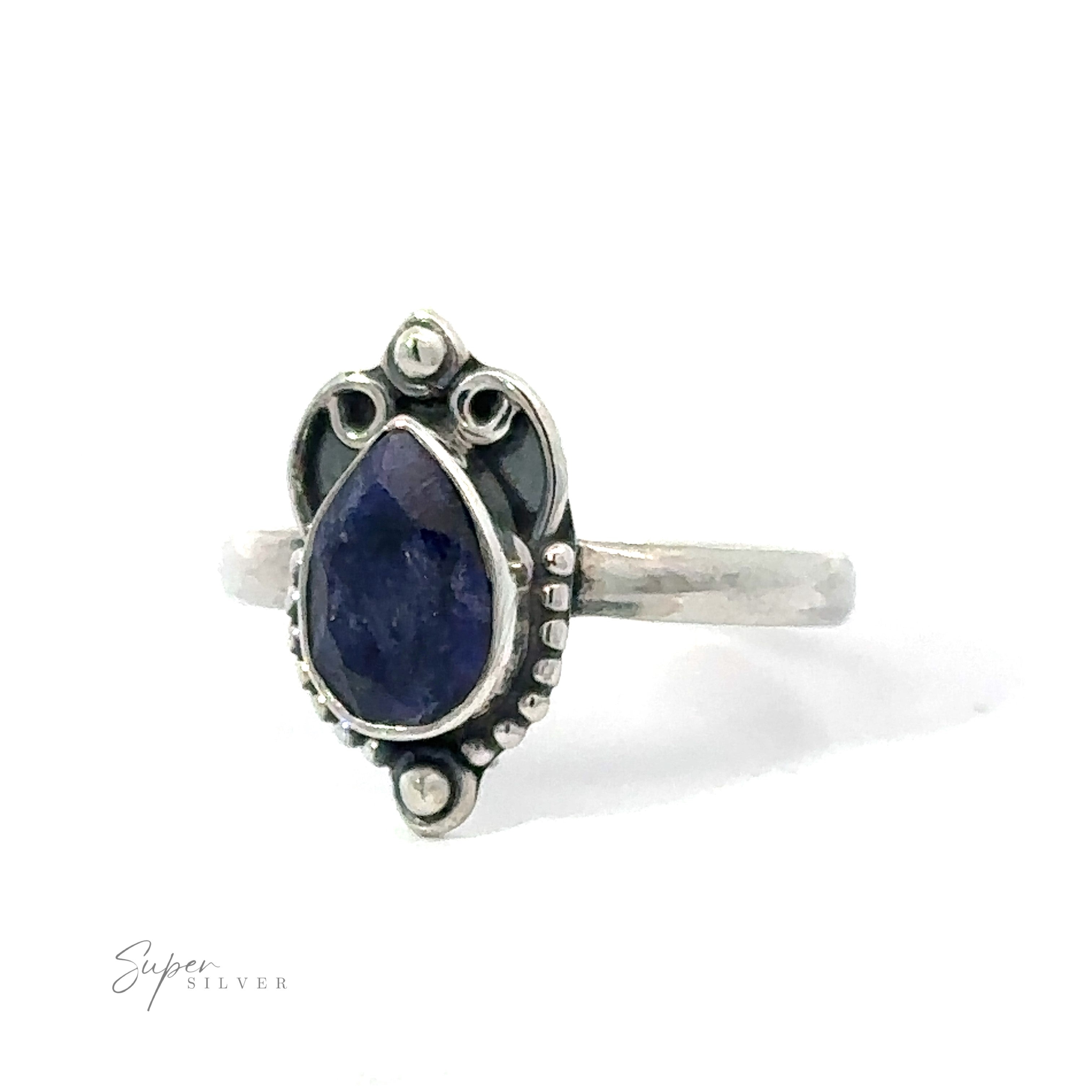 Vintage Inspired Teardrop Gemstone ring with a pear-shaped blue stone and decorative metalwork, displayed on a white background.