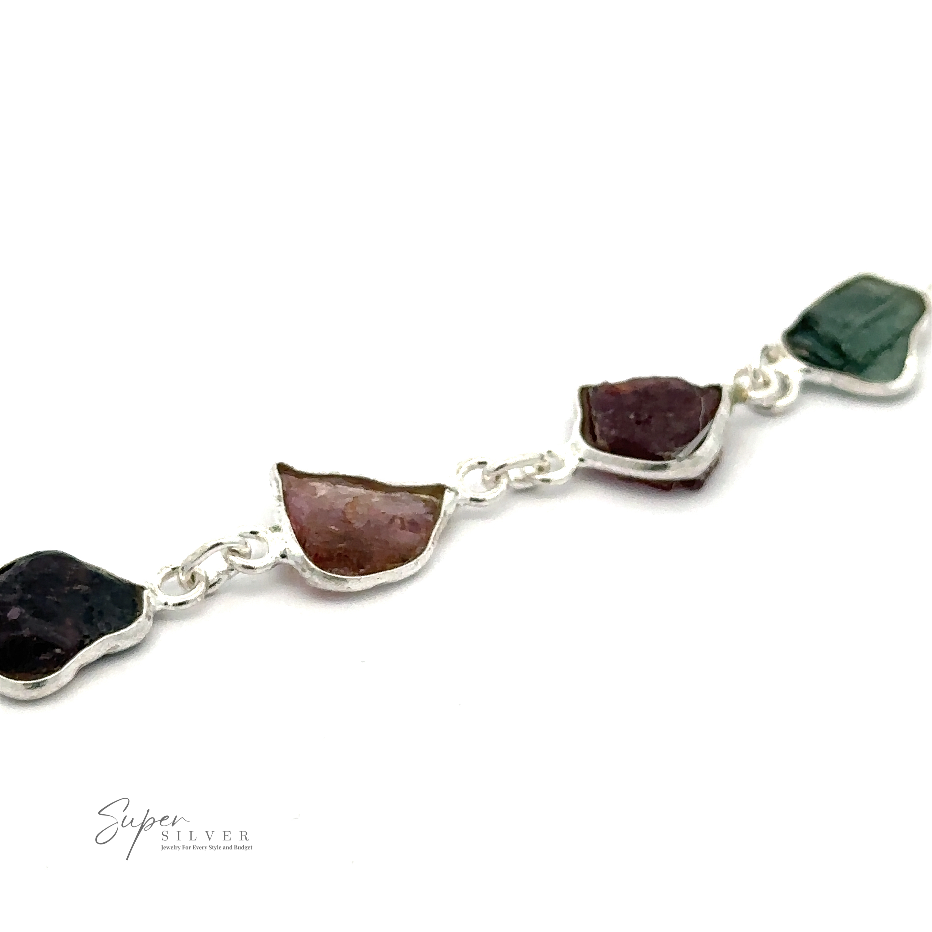 A Rough Tourmaline Bracelet featuring irregularly shaped, earthy elegance with multicolored rough tourmaline stones linked together. The stones vary in shades of green, purple, and pink. The logo "Super Silver" is visible in the bottom left corner.