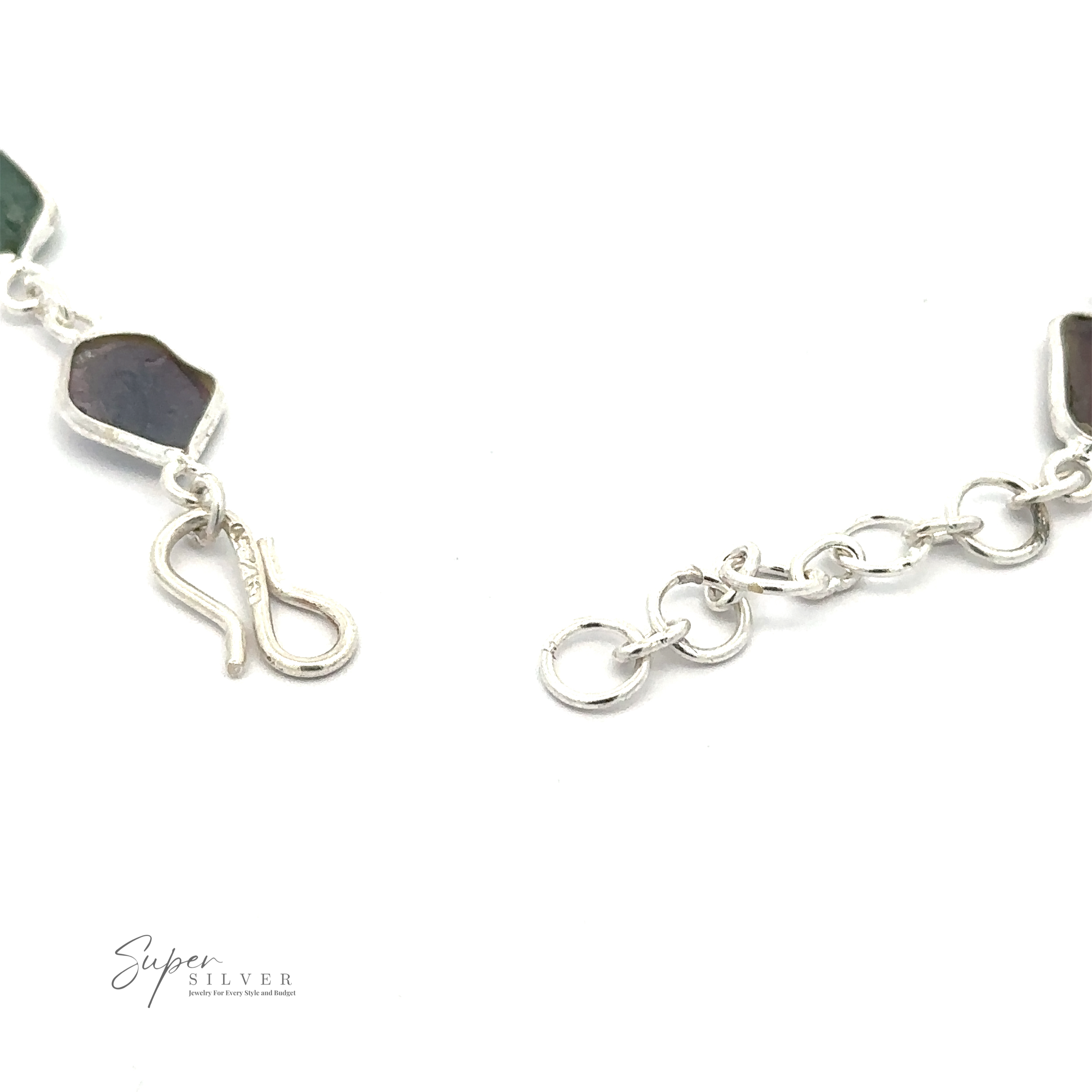 Close-up of a Rough Tourmaline Bracelet with a hook clasp and rough tourmaline stones in green and dark hues, exuding earthy elegance. The logo "Super Silver" is visible in the bottom left corner.