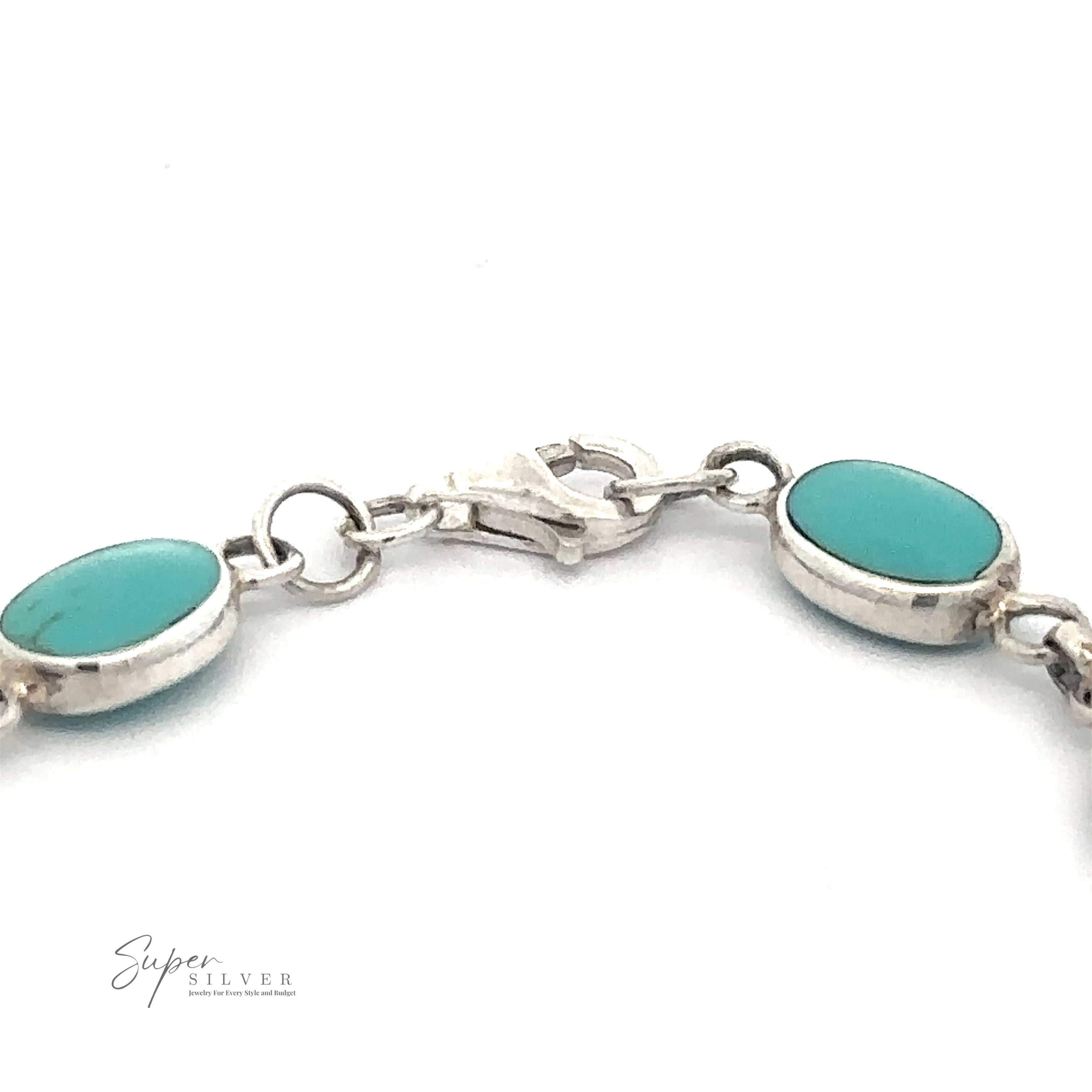 A close-up image of an Oval Turquoise Bracelet featuring oval turquoise stones. The clasp and chain links are visible, with the logo "Super Silver" seen in the bottom left corner.