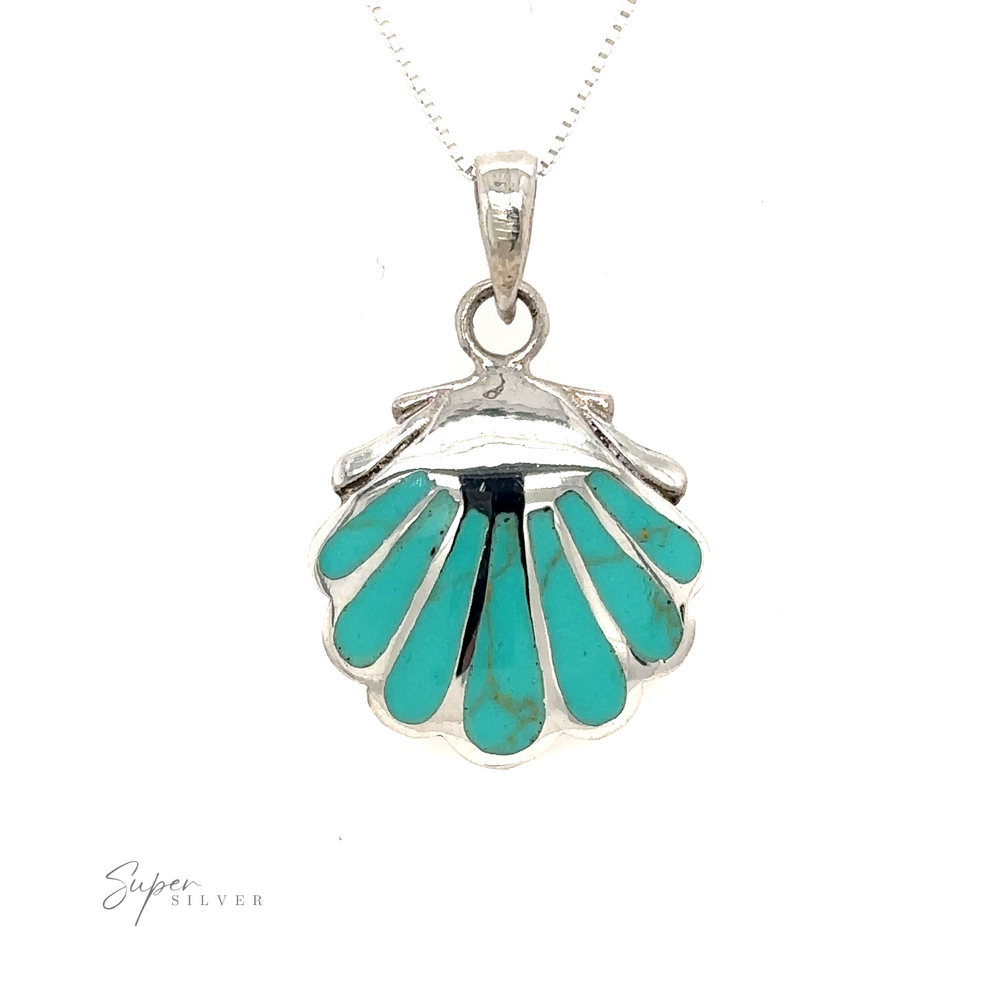 
                  
                    A Clam Shell Pendant, featuring inlay stones, beautifully showcased on a silver chain.
                  
                