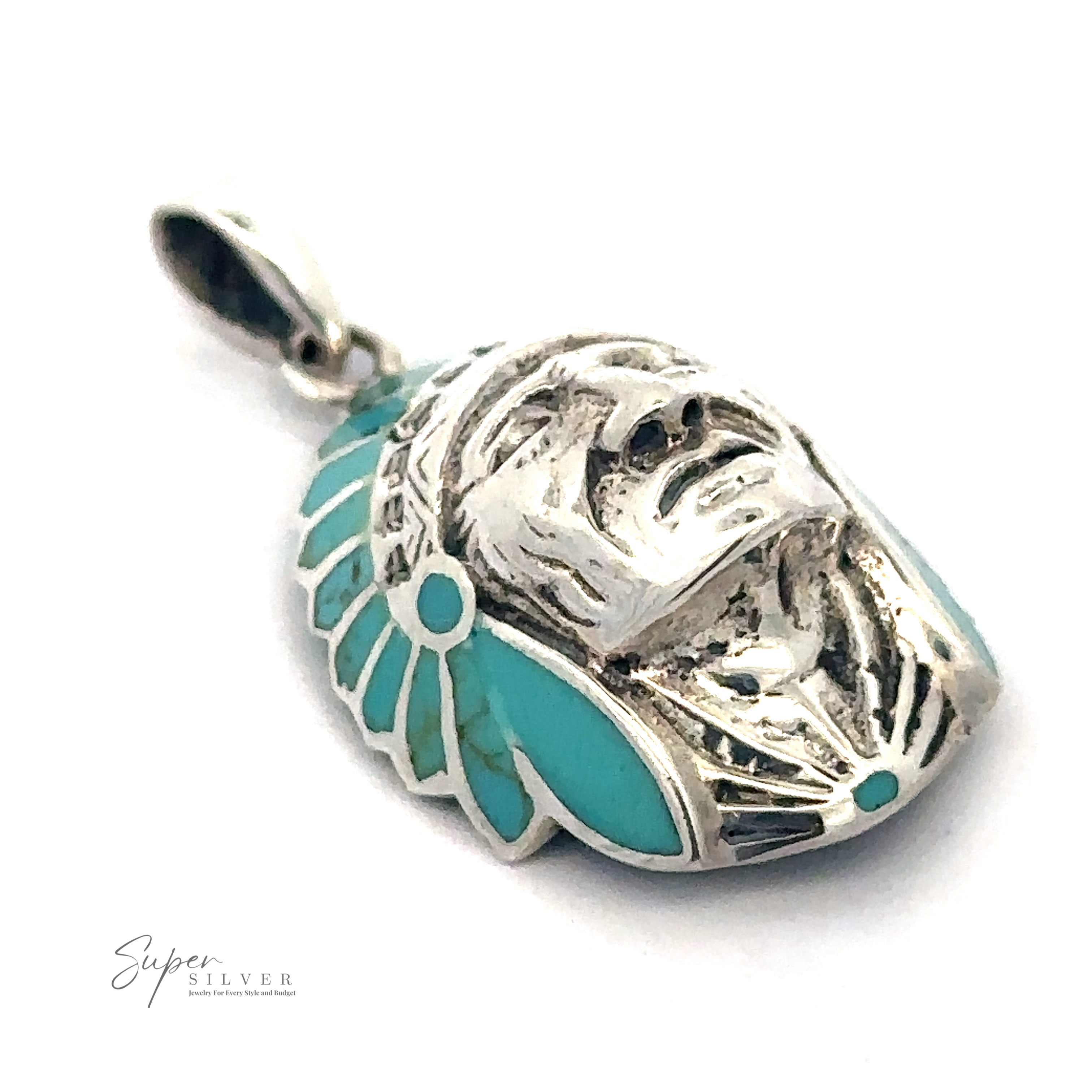 A sterling silver pendant featuring a turquoise-studded human face adorned with an elaborate headdress. The "Super Silver" logo is visible in the bottom left corner, making this Turquoise Chief Head Pendant a standout piece.