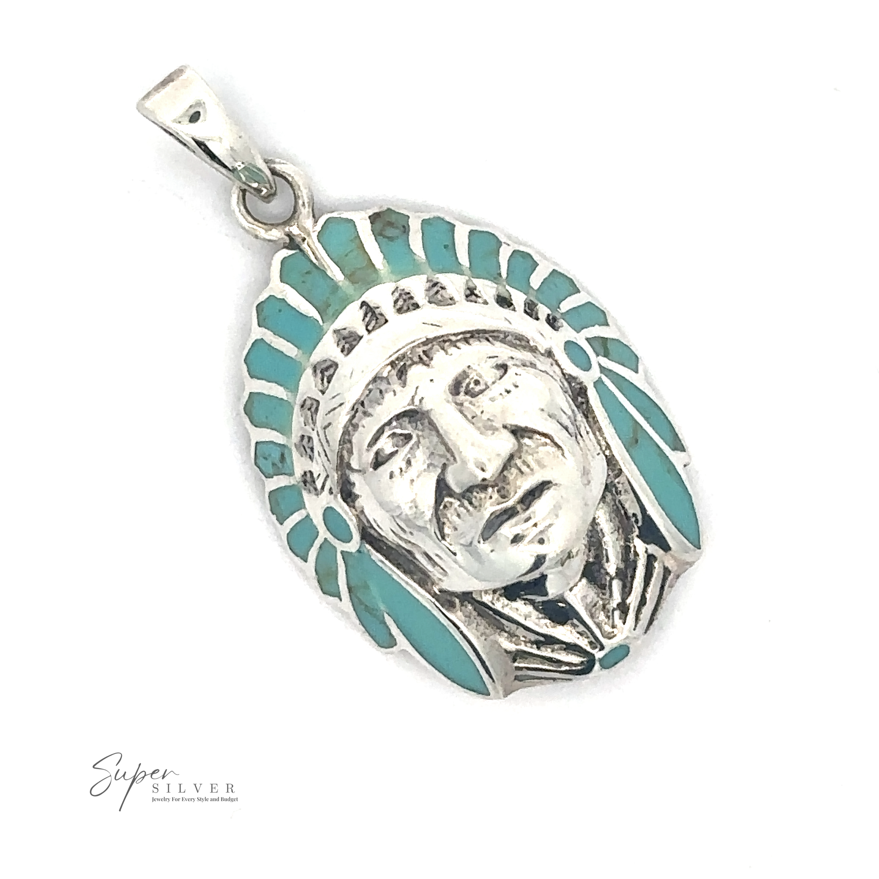 A stunning silver pendant featuring a detailed face adorned with a feathered headpiece and teal accents, this Turquoise Chief Head Pendant incorporates turquoise stones. The "Super Silver" logo is elegantly displayed in the bottom left corner.