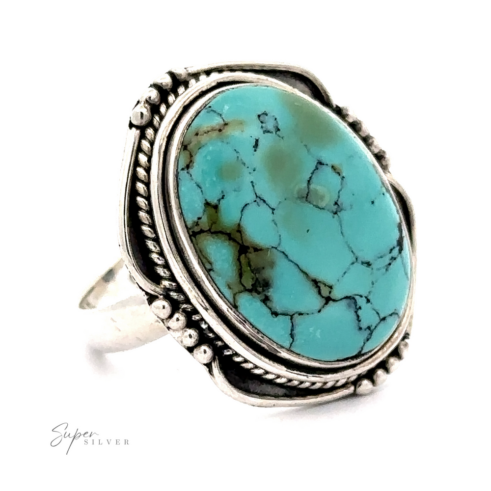 A Natural Turquoise Ring With Rope Design featuring a natural turquoise stone with black veining, set in a decorative vintage-style bezel setting. The oval-shaped gem is perfectly highlighted by the intricate design. The Super Silver brand logo is visible in the bottom left corner.