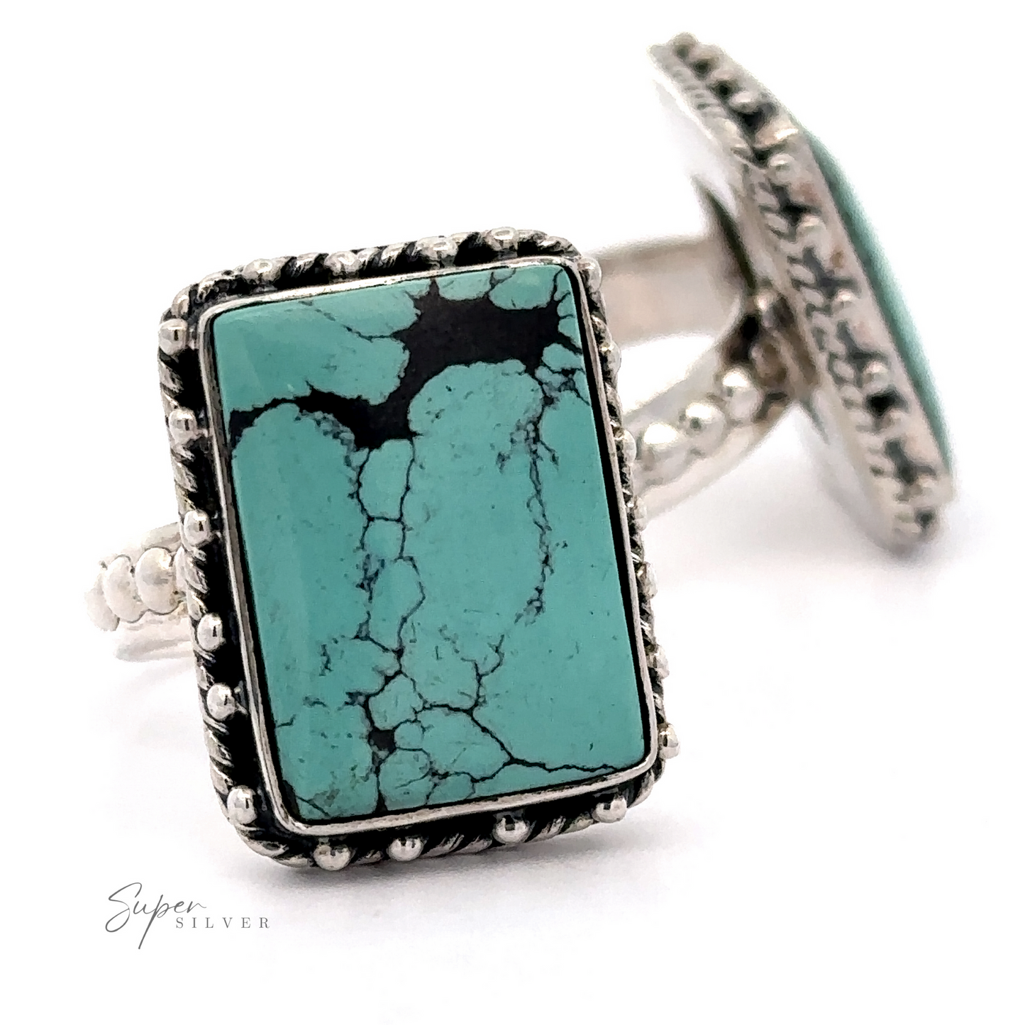 Close-up of two Rectangular Shape Natural Turquoise Ring With Ball Border rings with sterling silver bands and ornate detailing, displaying distinct black vein patterns. "Super Silver" text is visible. Rings are positioned upright on a white background.