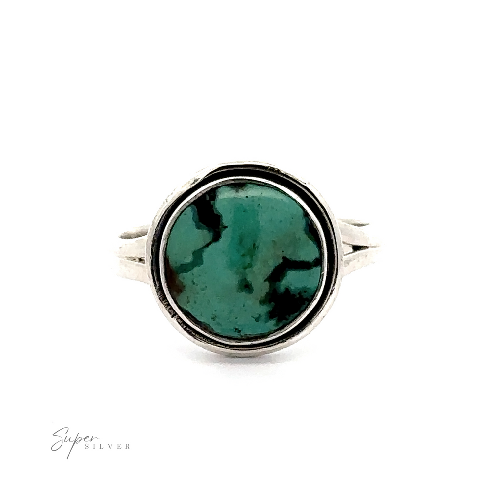 A Round Natural Turquoise Ring With Plain Border featuring a round, natural turquoise stone with dark green marbling. The ring showcases a unique pattern and double-band design.