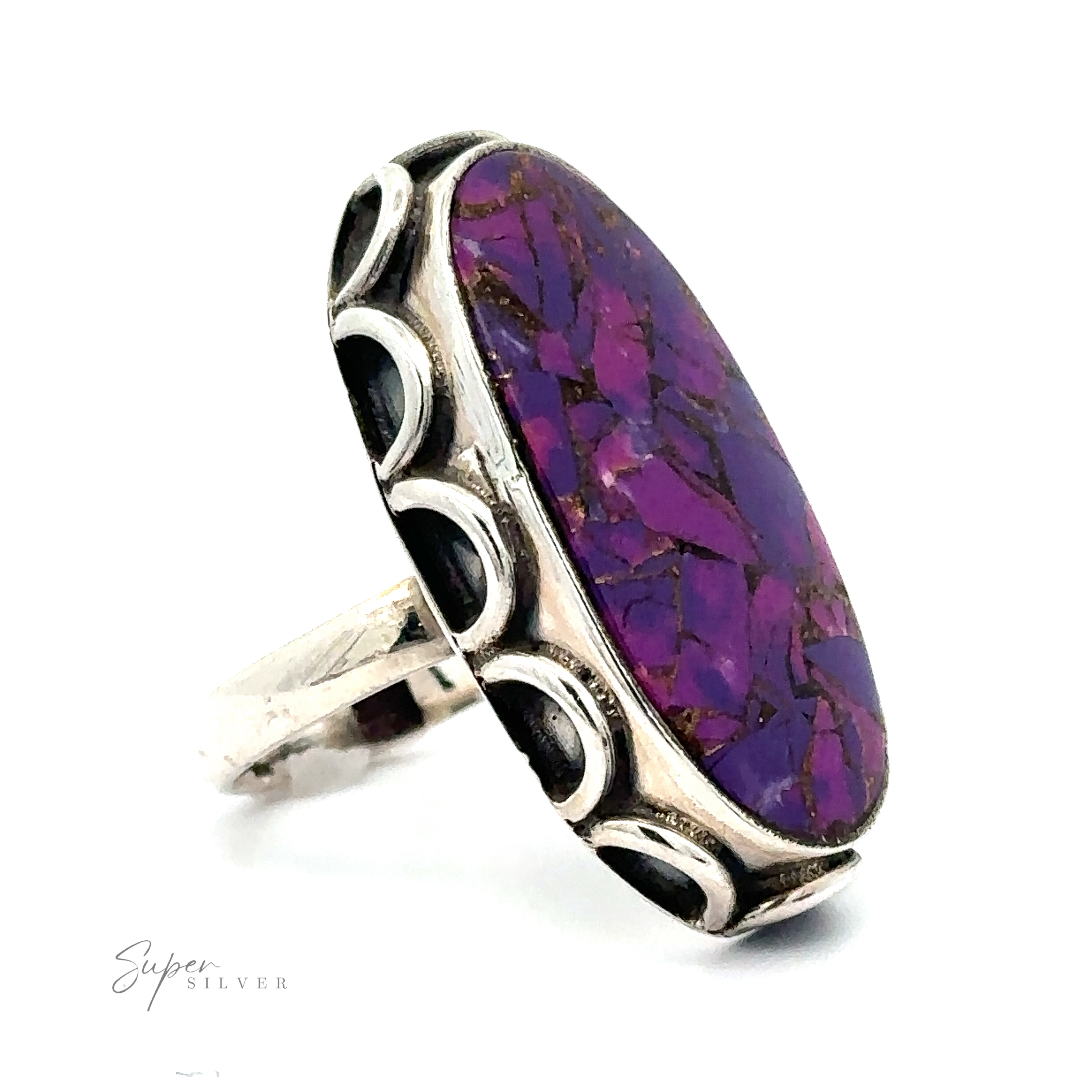 A Statement Purple Turquoise Ring featuring an oval-shaped purple stone with a mosaic pattern, set in a decorative silver band.