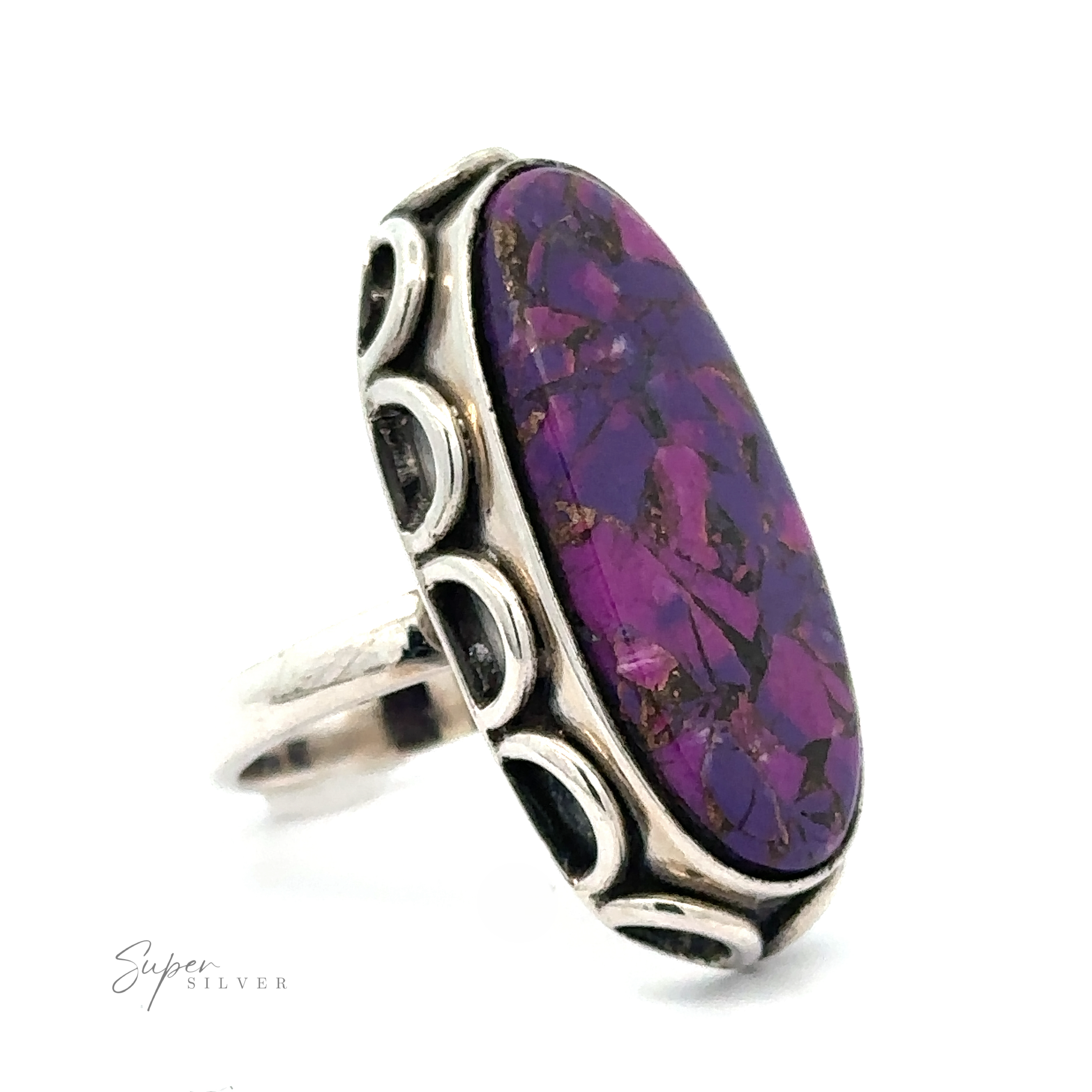 A silver ring featuring a large, oval-shaped Statement Purple Turquoise Ring stone with intricate silver detailing around the band. The text "Super Silver" appears in the corner.