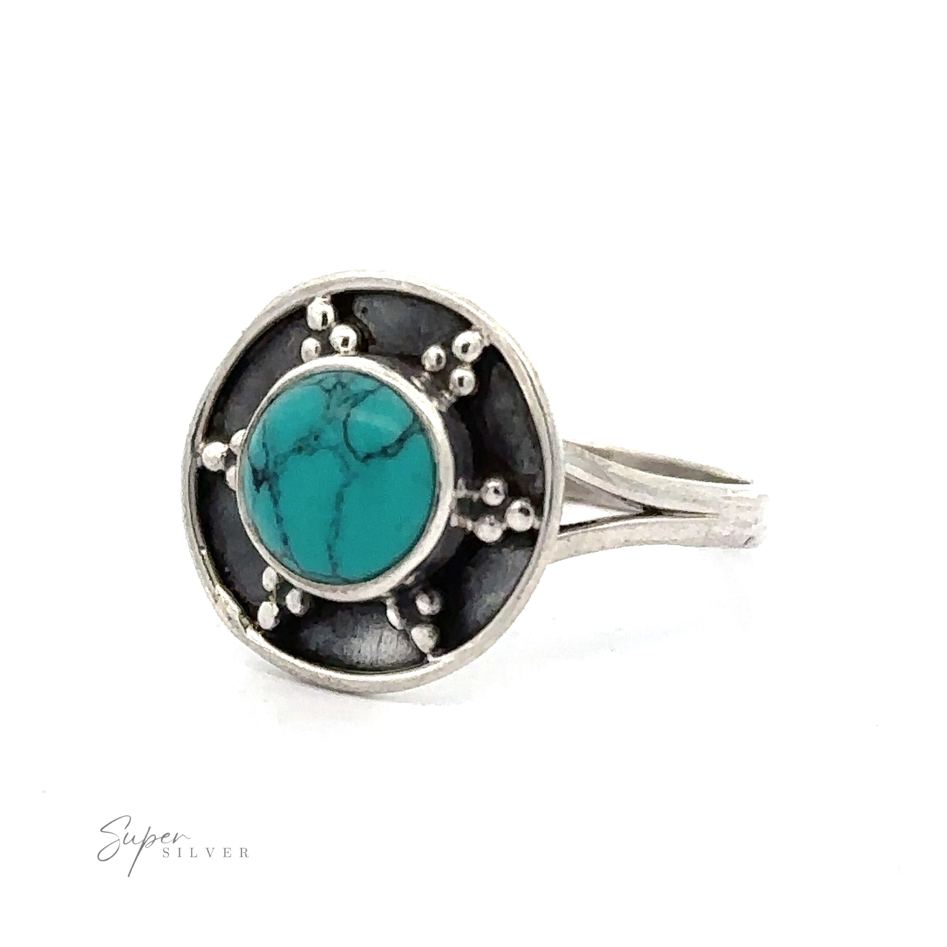 Silver ring with a round turquoise stone in the center, surrounded by small silver beads on an oxidized silver background. The band's design is simple and elegant. The words "Gemstone Ring With Unique Oxidized Design" are visible, marking this piece of gemstone jewelry as truly special.