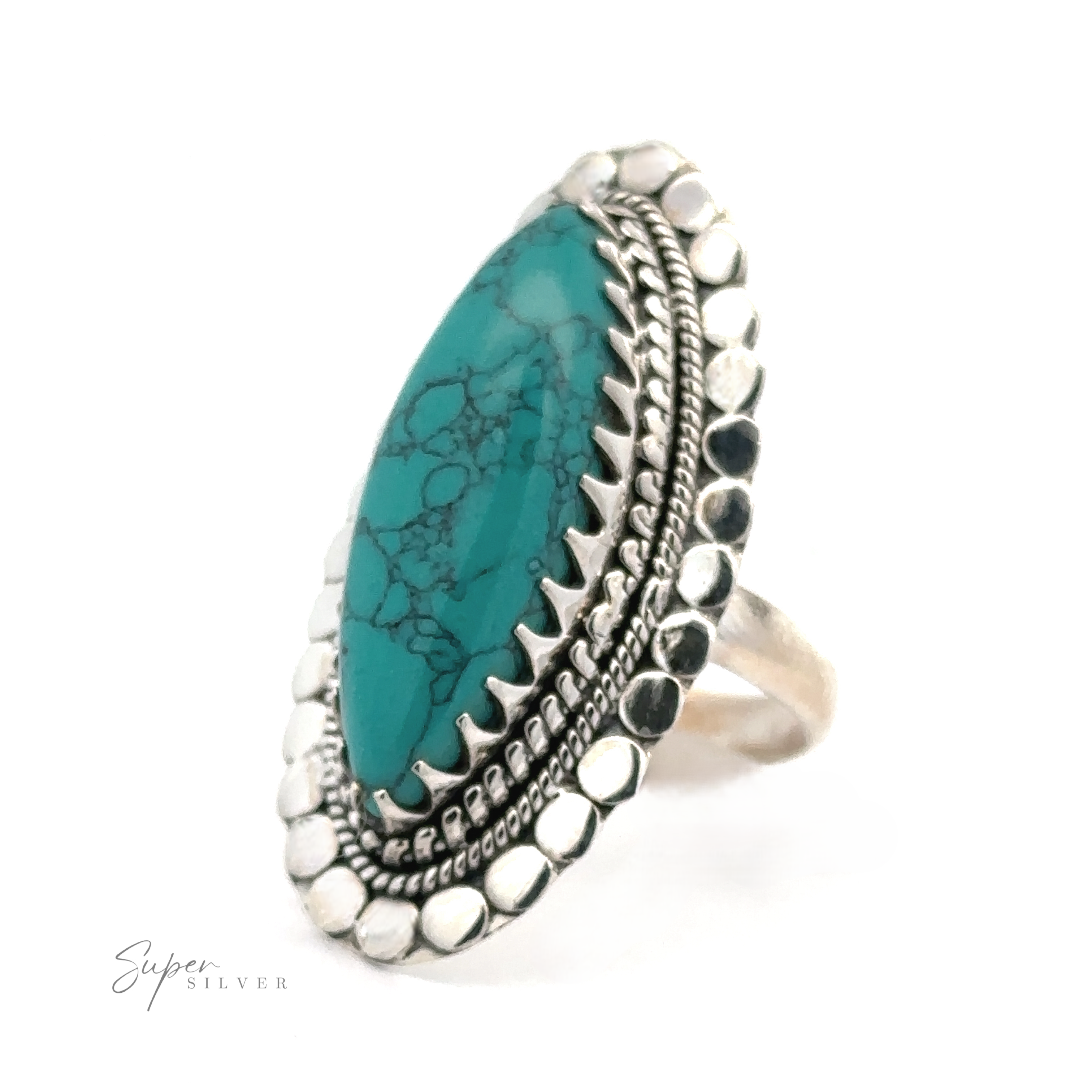 A Statement Marquise Shaped Gemstone Ring featuring an elongated turquoise stone with black veining, surrounded by an ornate beaded and scalloped design, embodies the essence of bohemian jewelry.