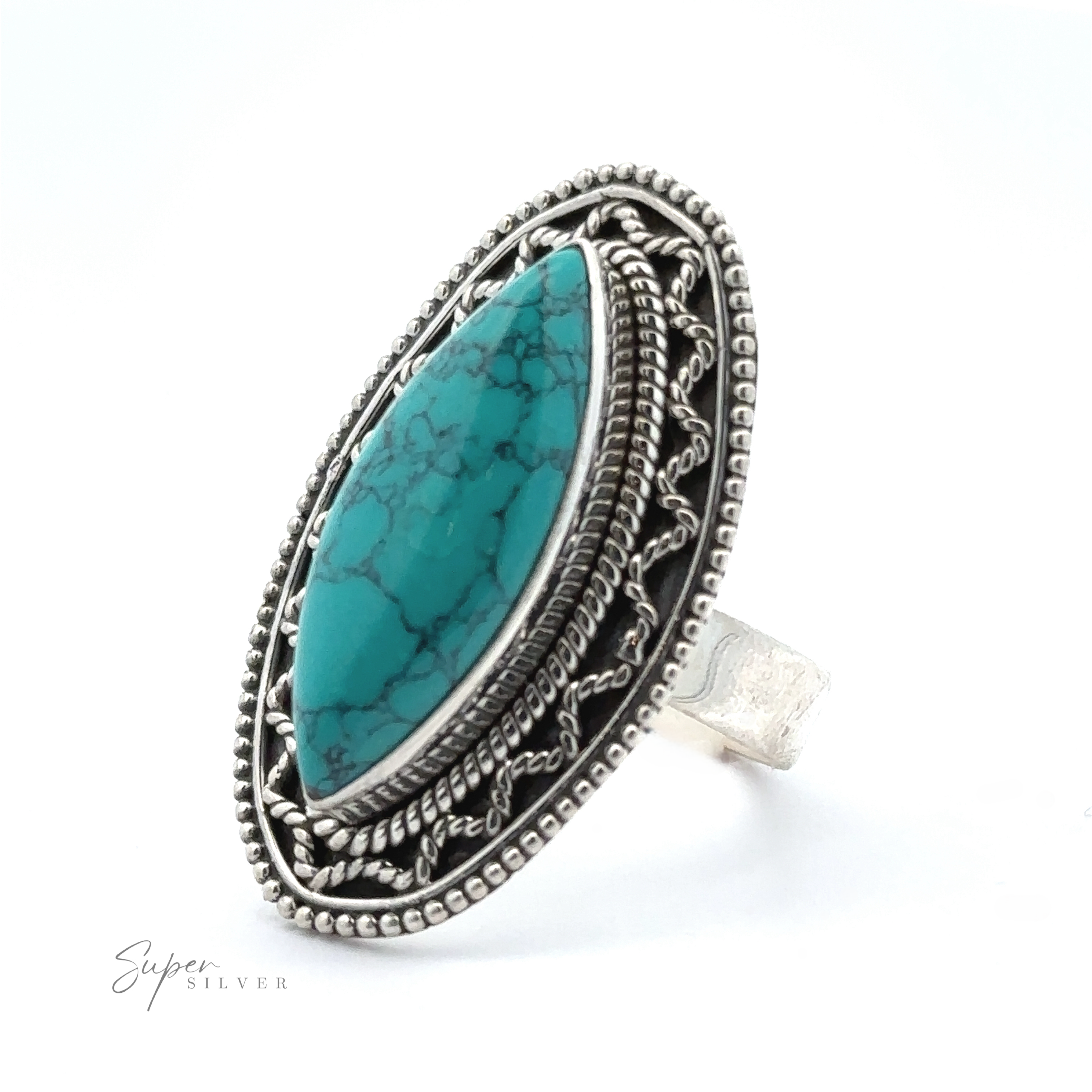 A silver ring featuring an oval turquoise stone set within an intricate, decorative border. With natural veining and a Bohemian twist, the Marquise Shaped Gemstone Ring With Vintage Shield Border is marked 'Super Silver.'