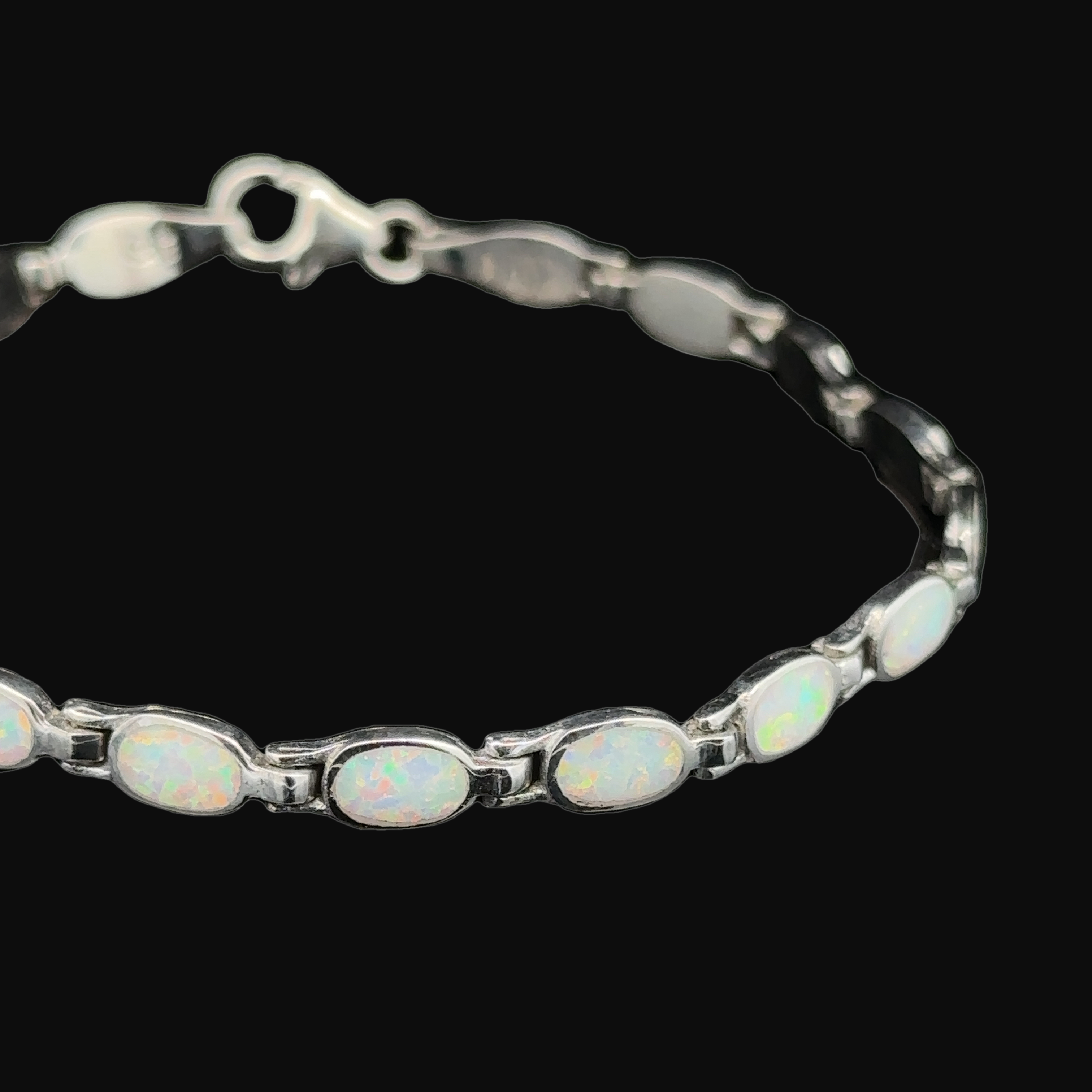 The Oval Lab-Created Opal Bracelet showcases modern elegance with a series of oval lab-created opal stones set in .925 Sterling Silver.
