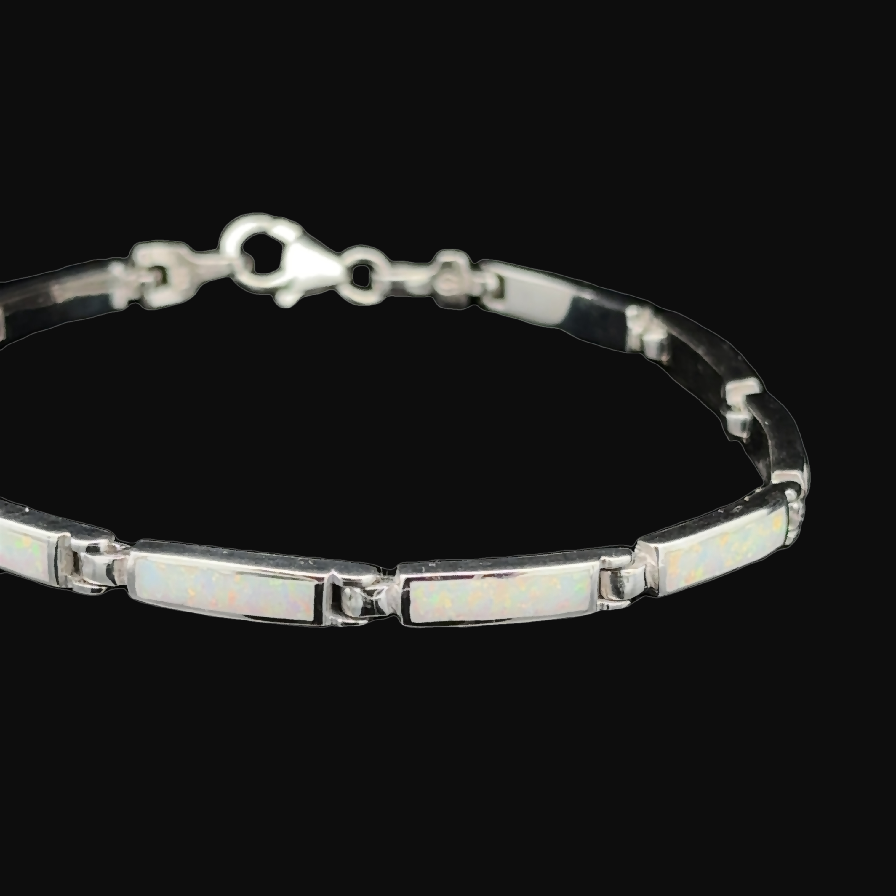Experience the charm of the Long Rectangle Lab-Created Opal Bracelet, a sterling silver piece featuring rectangular opal inlays set against a striking black background.