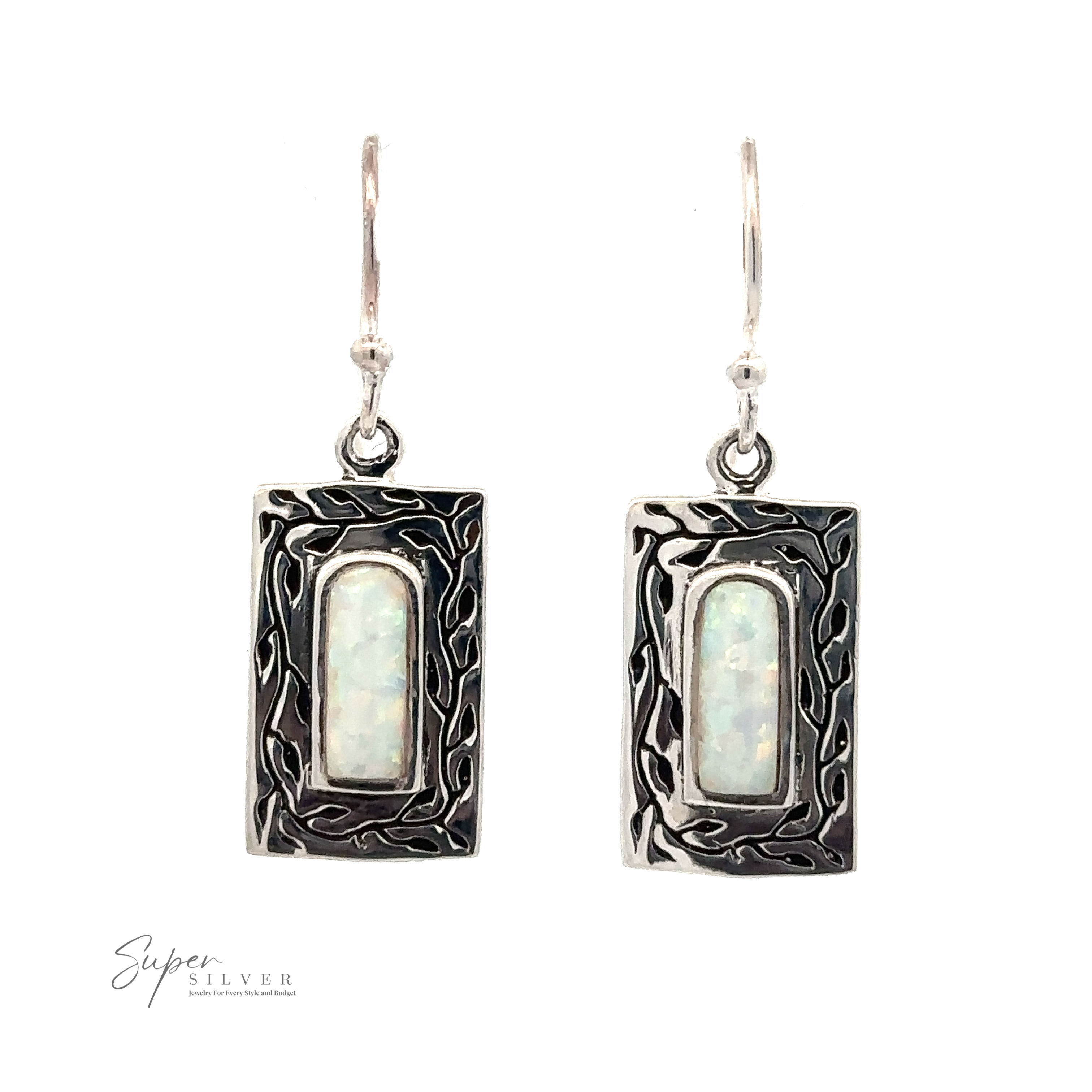 Rectangular sterling silver earrings with intricate designs surrounding oval-shaped, lab-created opal stones. "White Created Opal Square Earrings" brand logo visible in the lower-left corner.