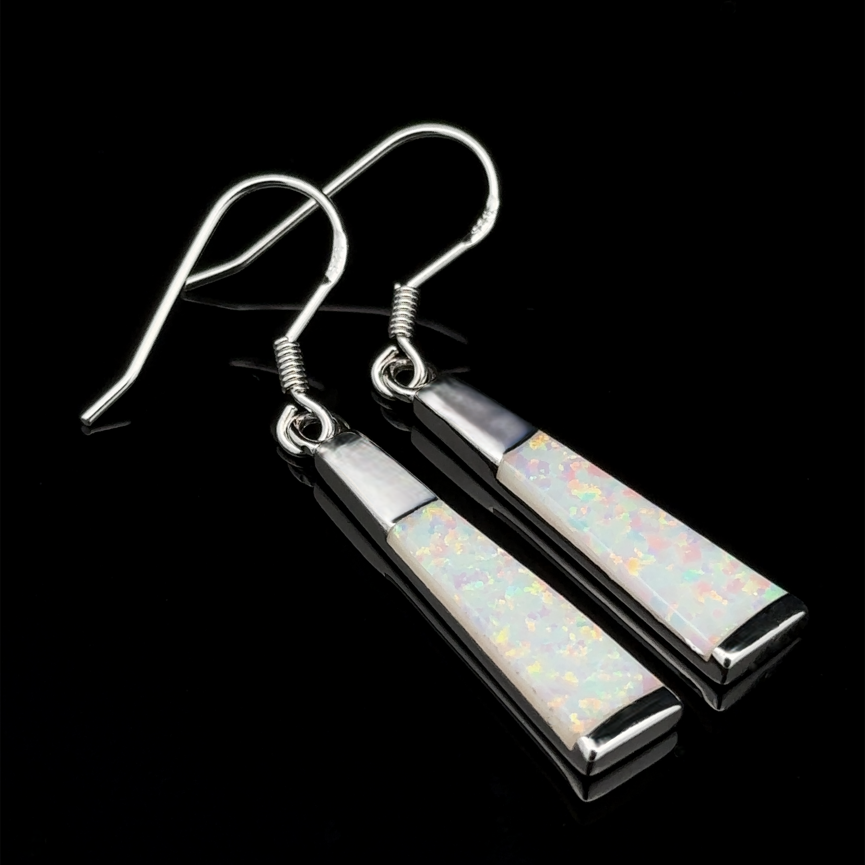 These Elegant Long Opal Earrings exude modern elegance with their elongated flared rectangle shapes and lab-created opal inlays set against a sleek black background.