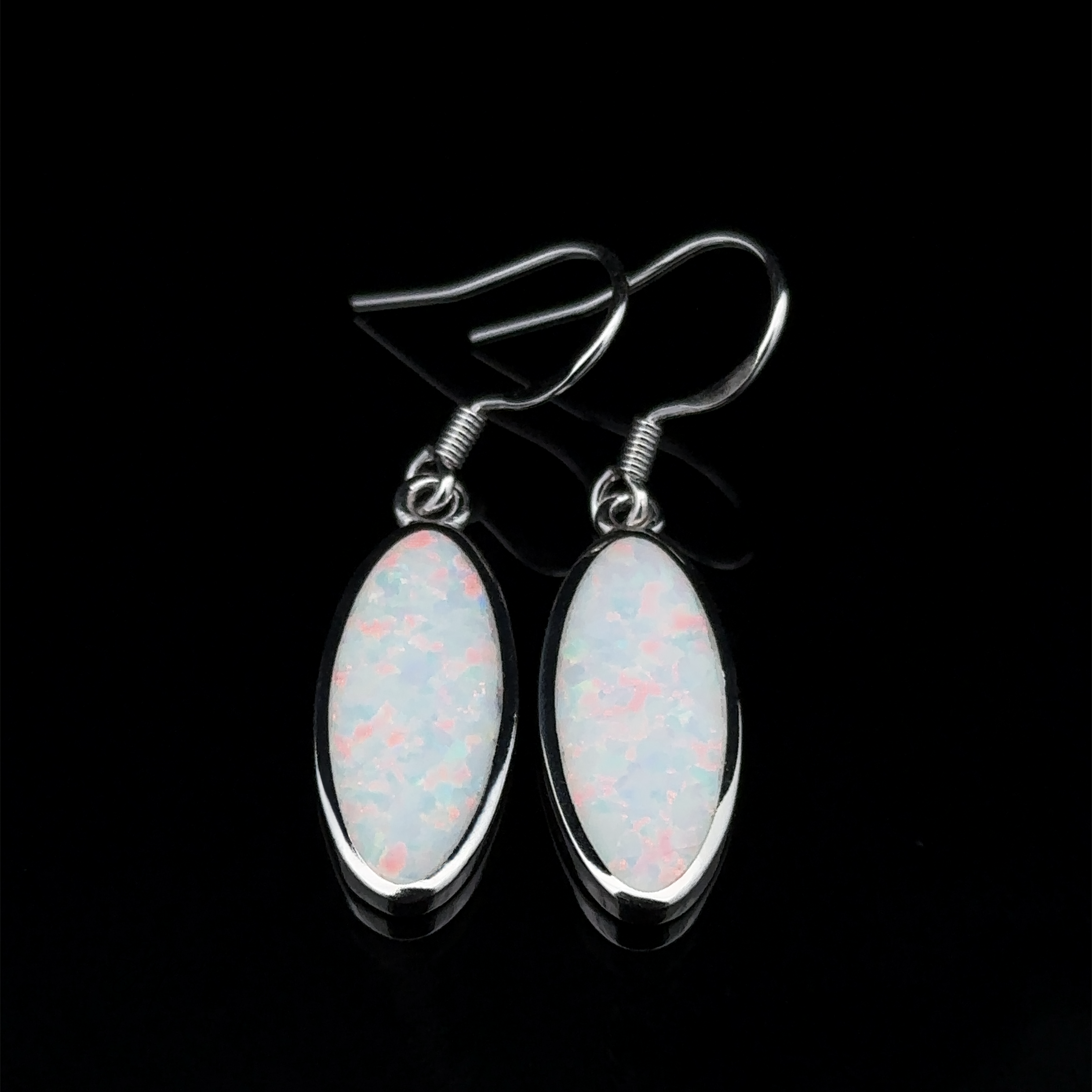 A pair of Simple Oval Lab-Created Opal Earrings featuring sterling silver and iridescent white lab-created opal stones on a black backdrop.