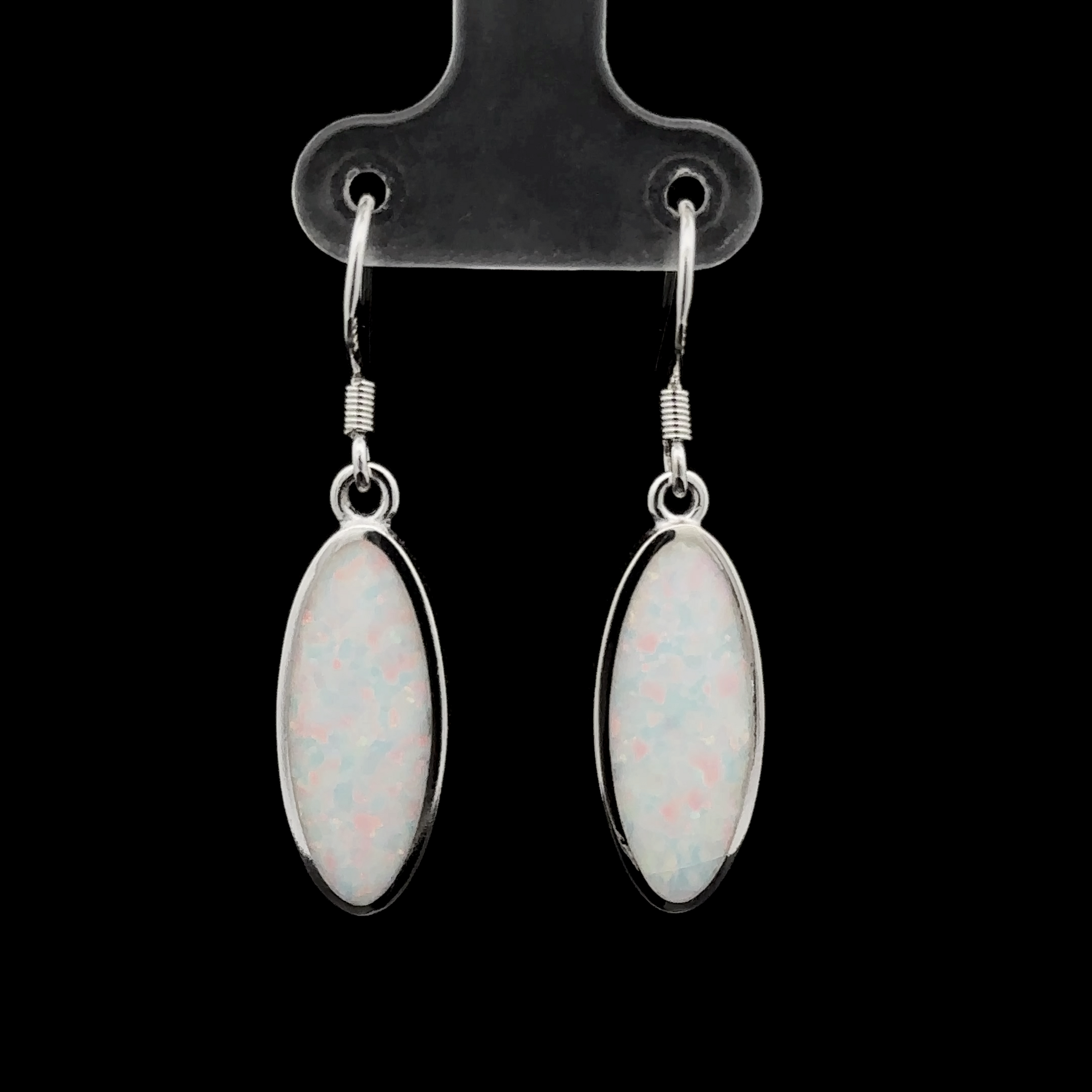 A pair of Simple Oval Lab-Created Opal Earrings with silver hooks displayed on a black background.