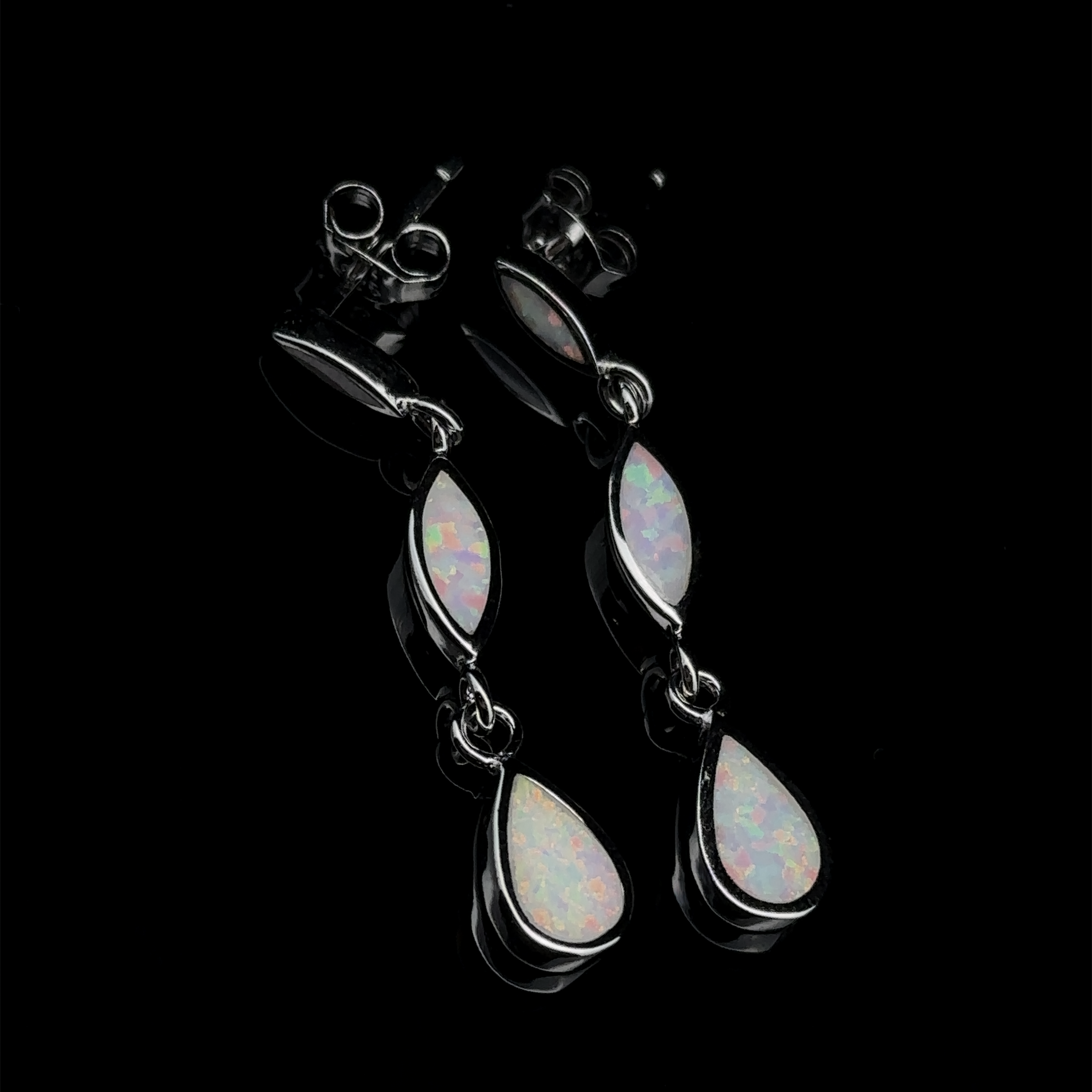 The Elegant Lab-Created Opal Earrings showcase sterling silver craftsmanship with marquise and teardrop-shaped lab-created opal stones set against a sleek black background.