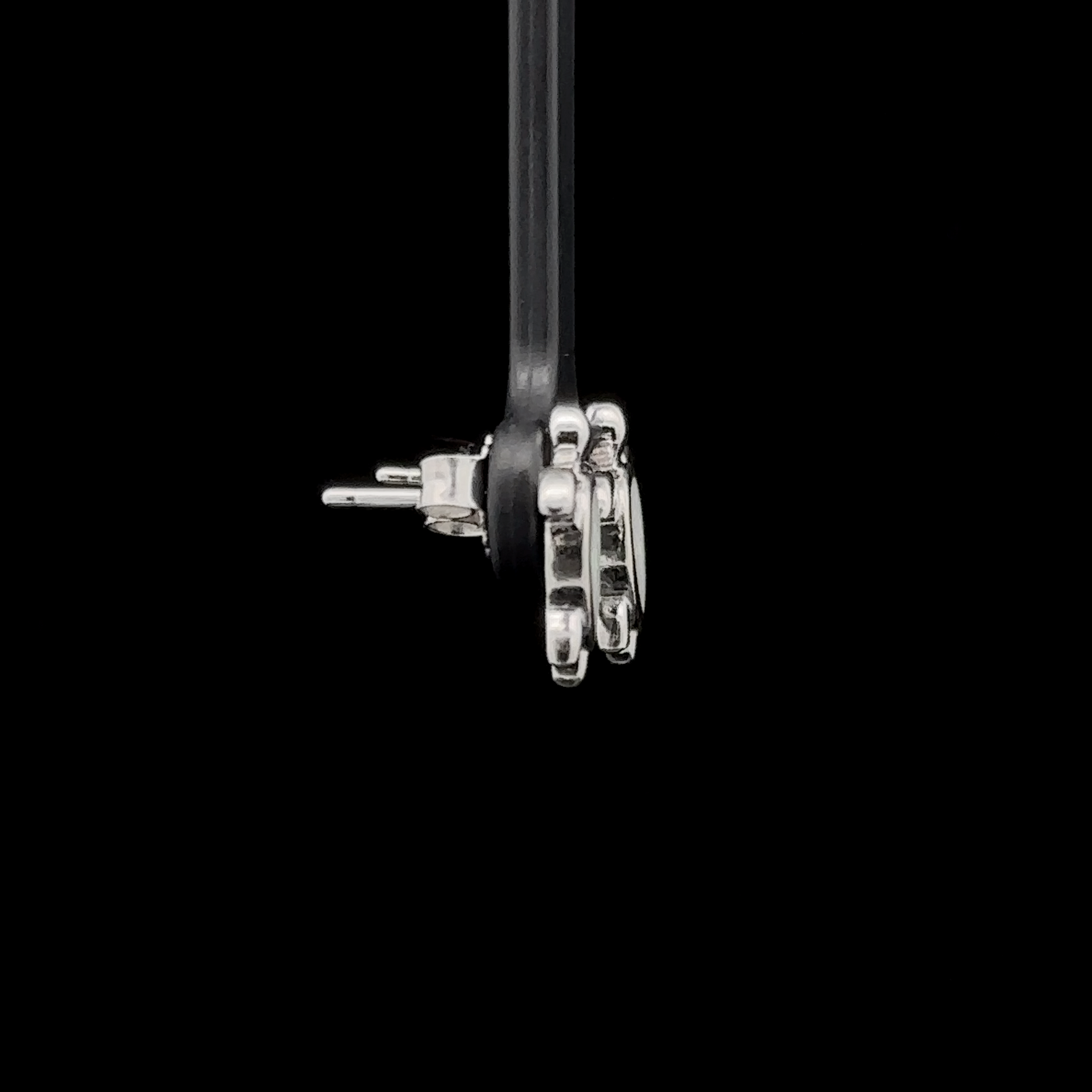 Side view of Simple Lab-Created Opal Turtle Studs with stud backings on a black background.