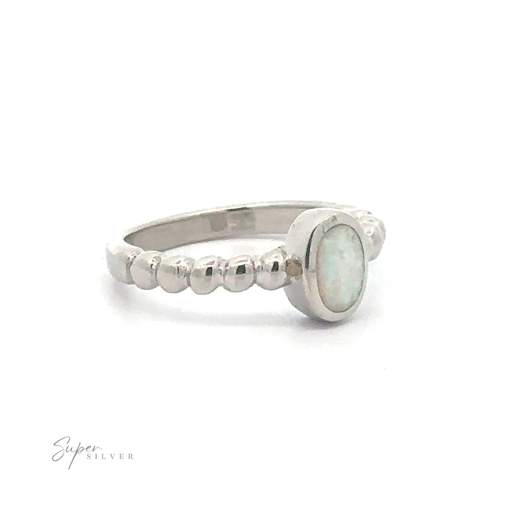 
                  
                    Oval Lab Opal with Beaded Band ring displayed against a white background.
                  
                