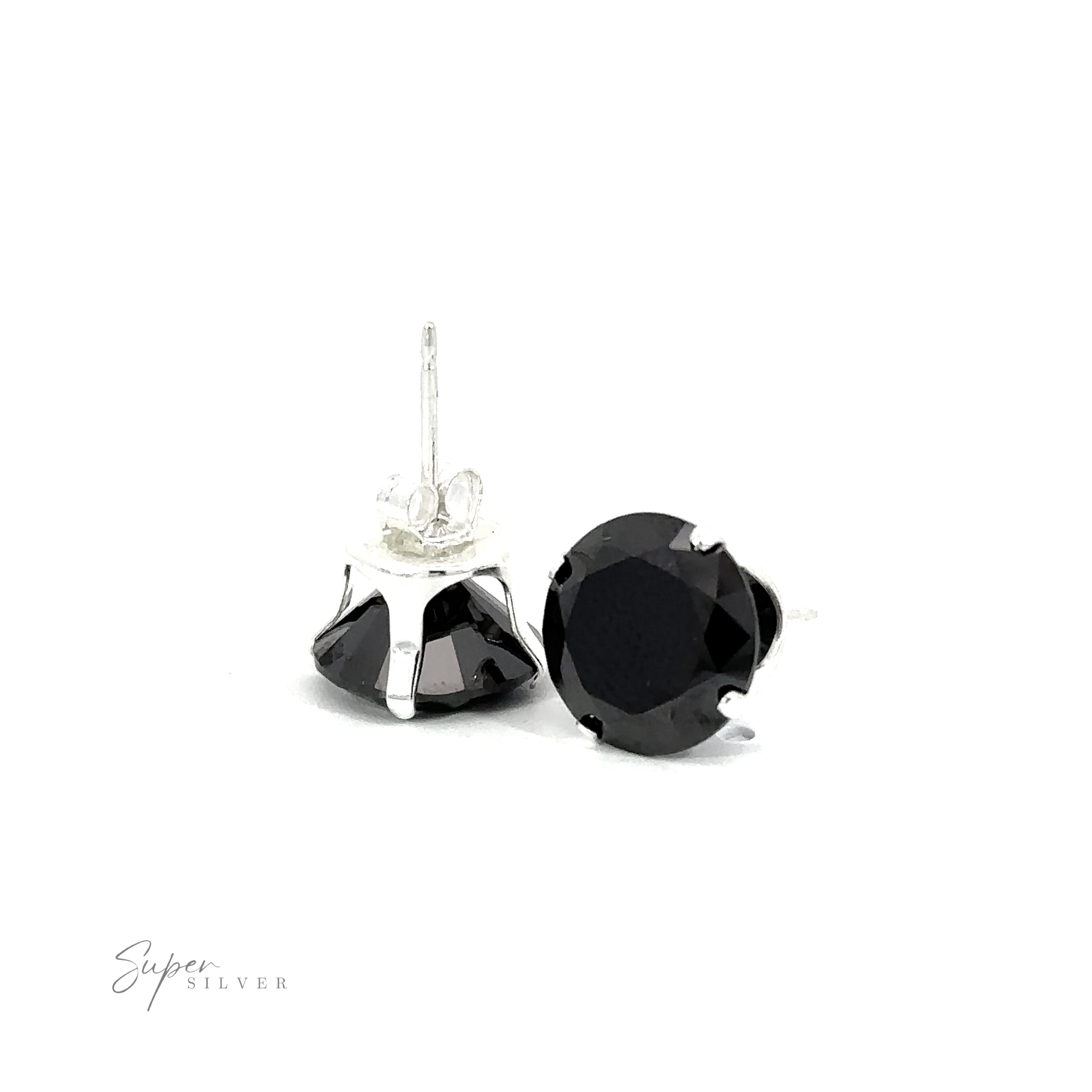 A pair of black round CZ stud earrings on a white surface.