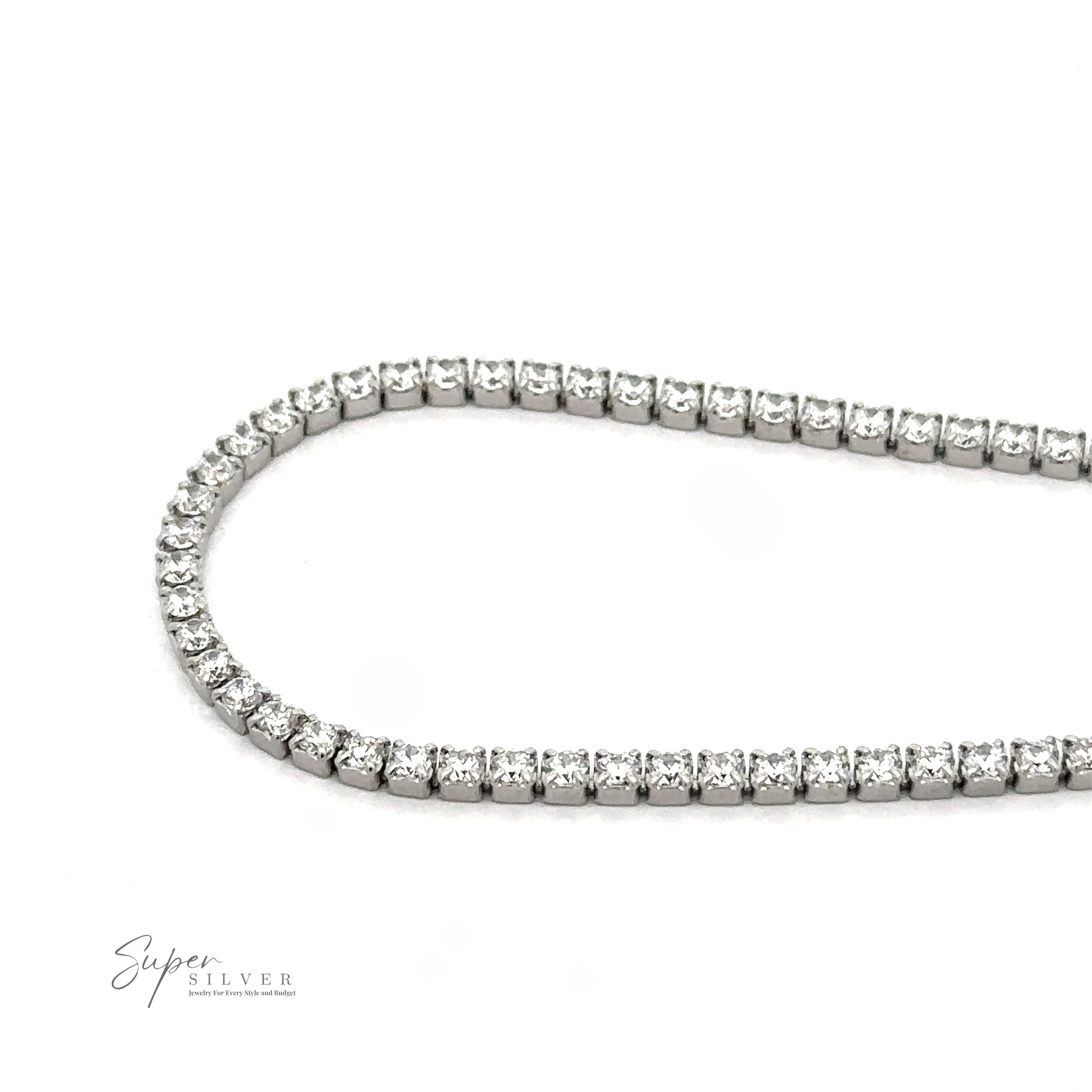 A silver necklace with a series of small, round gemstones set closely together, forming a partial loop on a white background. The image includes a small "Super Silver" logo in the bottom left corner, reminiscent of the elegance found in a Square Cubic Zirconia Tennis Bracelet.