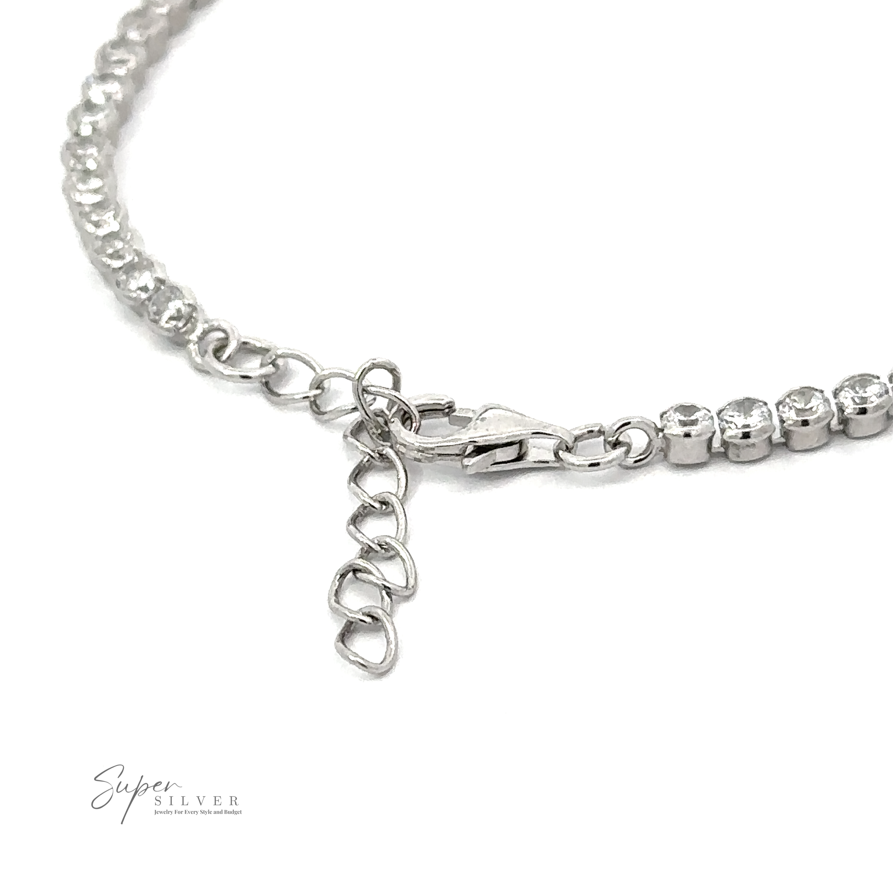 Close-up of a Round Cubic Zirconia Tennis Bracelet with a lobster clasp and extension chain, featuring rhinestones along its length. The brand name "Super Silver" is visible in the bottom left corner.