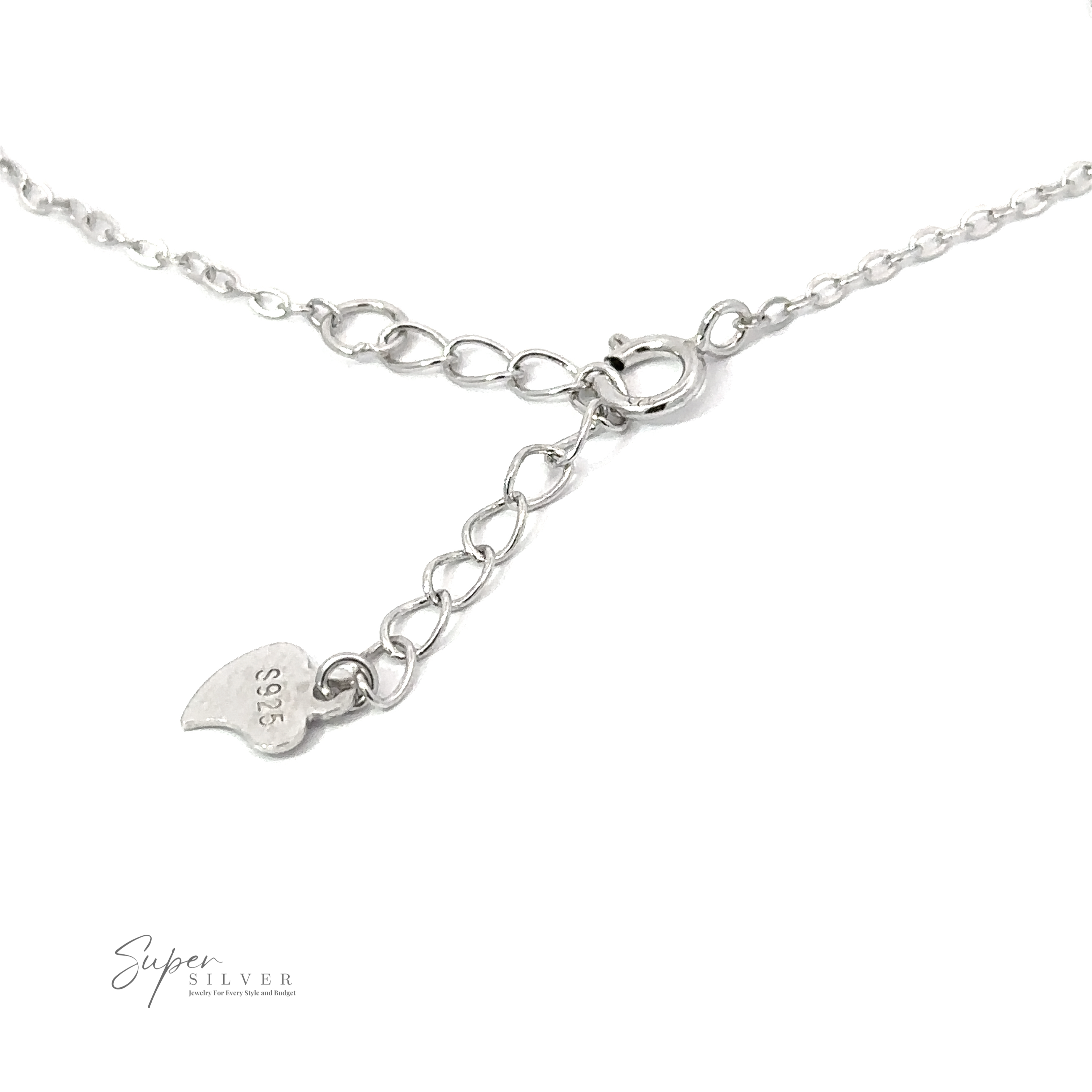 Close-up of a Delicate Cubic Zirconia Handcuff Bracelet with a small heart-shaped tag marked "925" and a lobster clasp. The background is white.