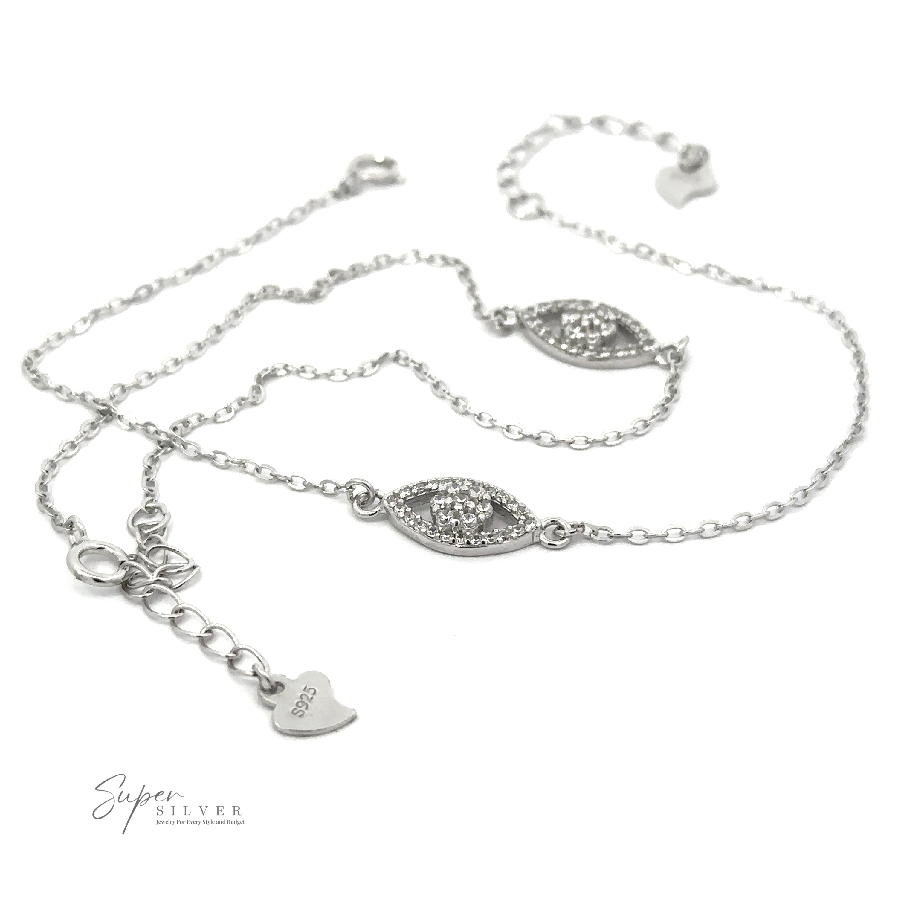 Delicate Dainty Cubic Zirconia Evil Eye Bracelet featuring two eye-shaped charms embedded with small Cubic Zirconia crystals and a heart-shaped clasp. Text "Super Silver" is visible at the bottom left corner.