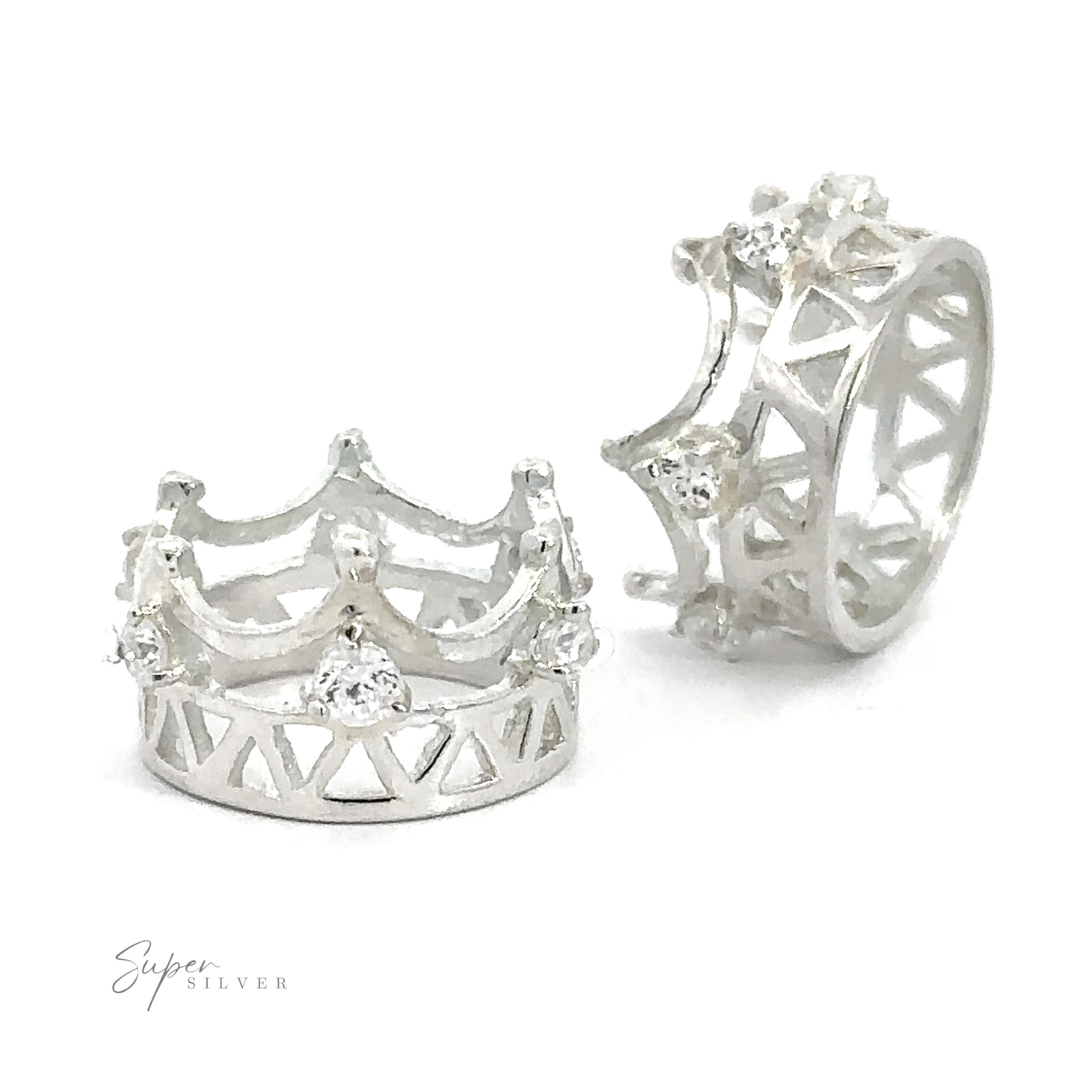 Two sterling silver crown-shaped rings with intricate designs and small cubic zirconia gemstones are displayed. The Cubic Zirconia Crown Pendant features openwork patterns and decorative elements. A small "Super Silver" logo is visible in the corner.