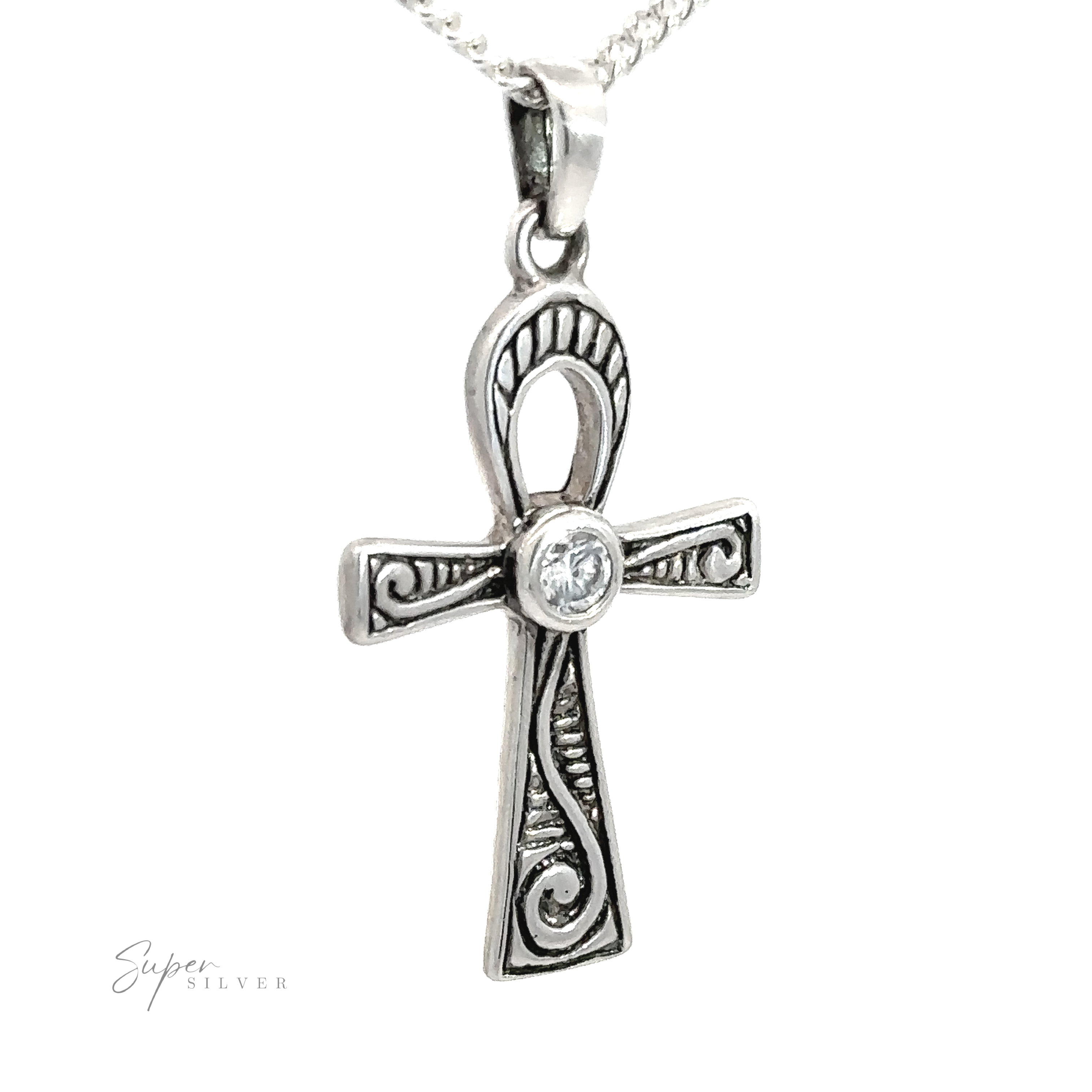The Cubic Zirconia Ankh Pendant features a sterling silver design with intricate engravings, a central clear cubic zirconia gemstone, and hangs from a silver chain.
