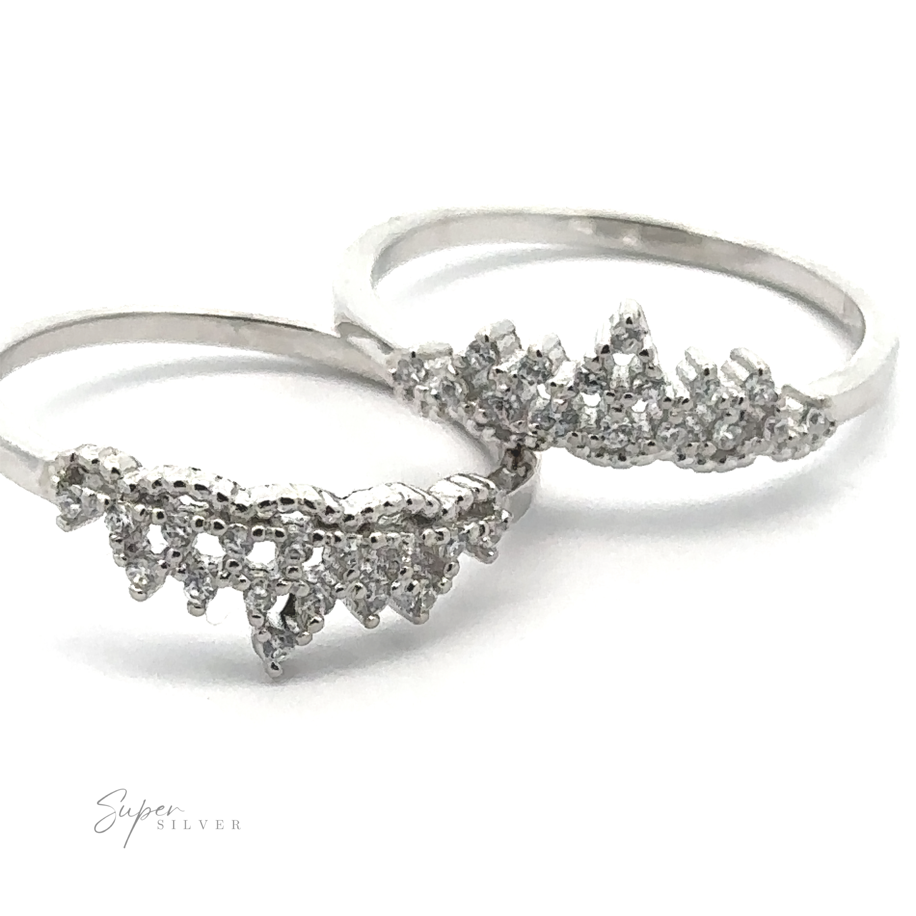 Two Dainty Cubic Zirconia Crown Rings, with intricate, pointed designs resembling delicate crowns, are positioned side by side against a white background. The fine details and the sparkle of cubic zirconia make these rings truly enchanting.