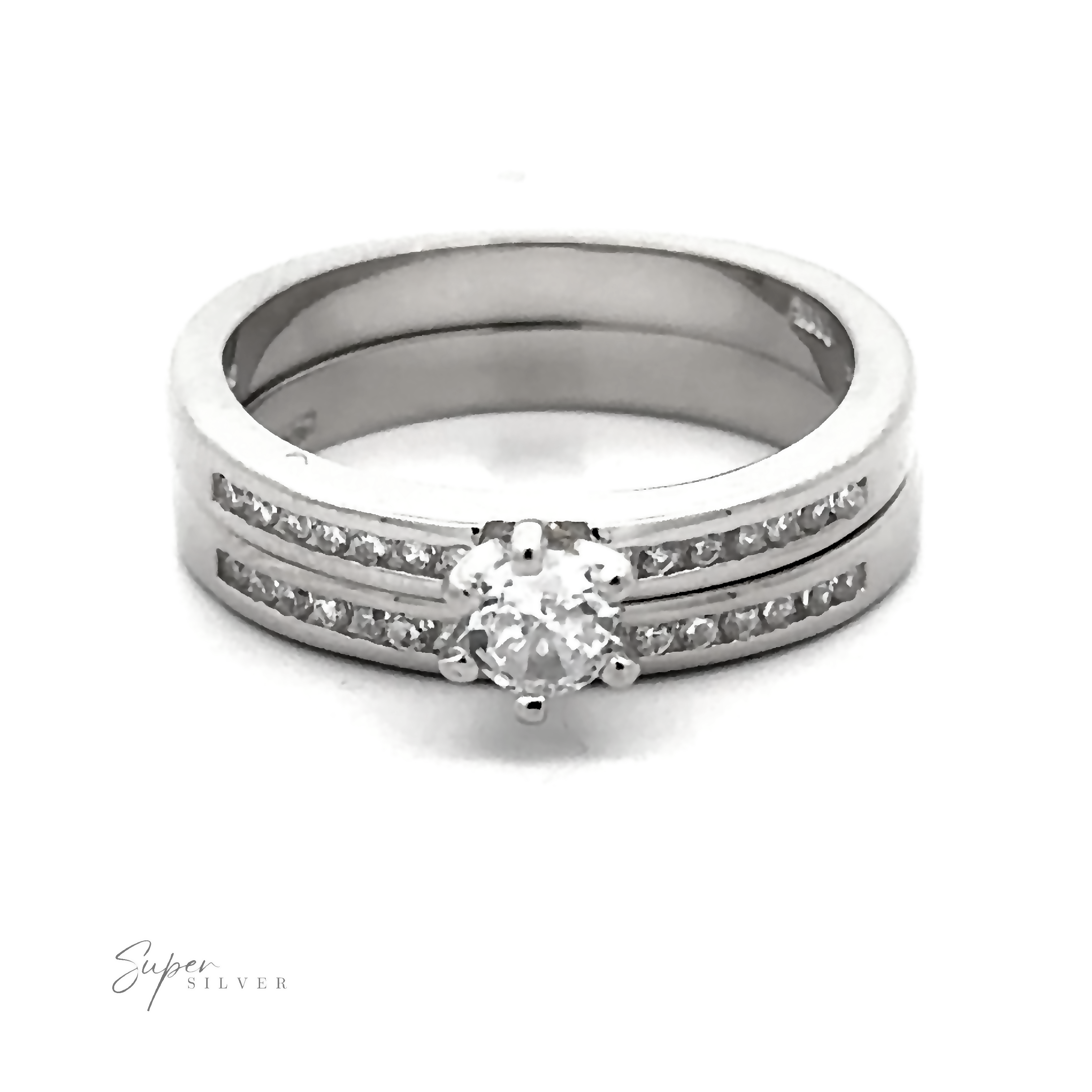 A Brilliant Round Cubic Zirconia Wedding Ring Set with rhodium finish, featuring a large central diamond flanked by two rows of smaller diamonds on the band. The Super Silver logo is visible in the bottom left corner.