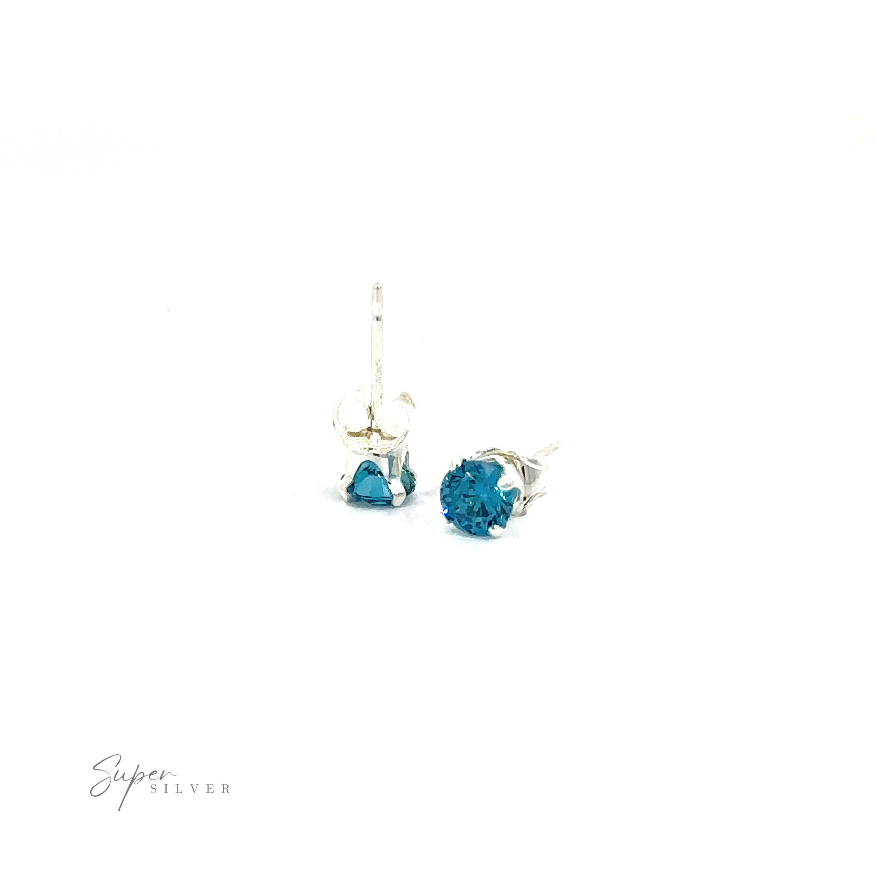 Pair of silver Round CZ studs with blue cubic zirconia on a white background.