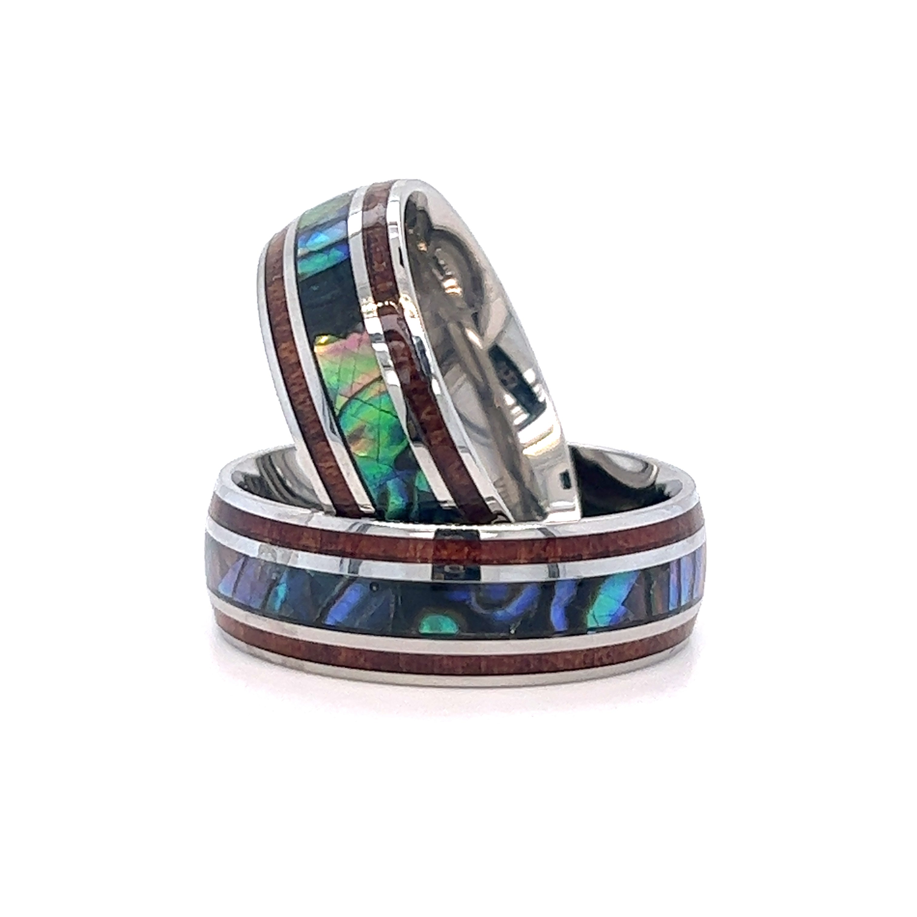 A pair of Super Silver Abalone and Koa Wood Stainless Steel Rings with abalone and wood inlay.