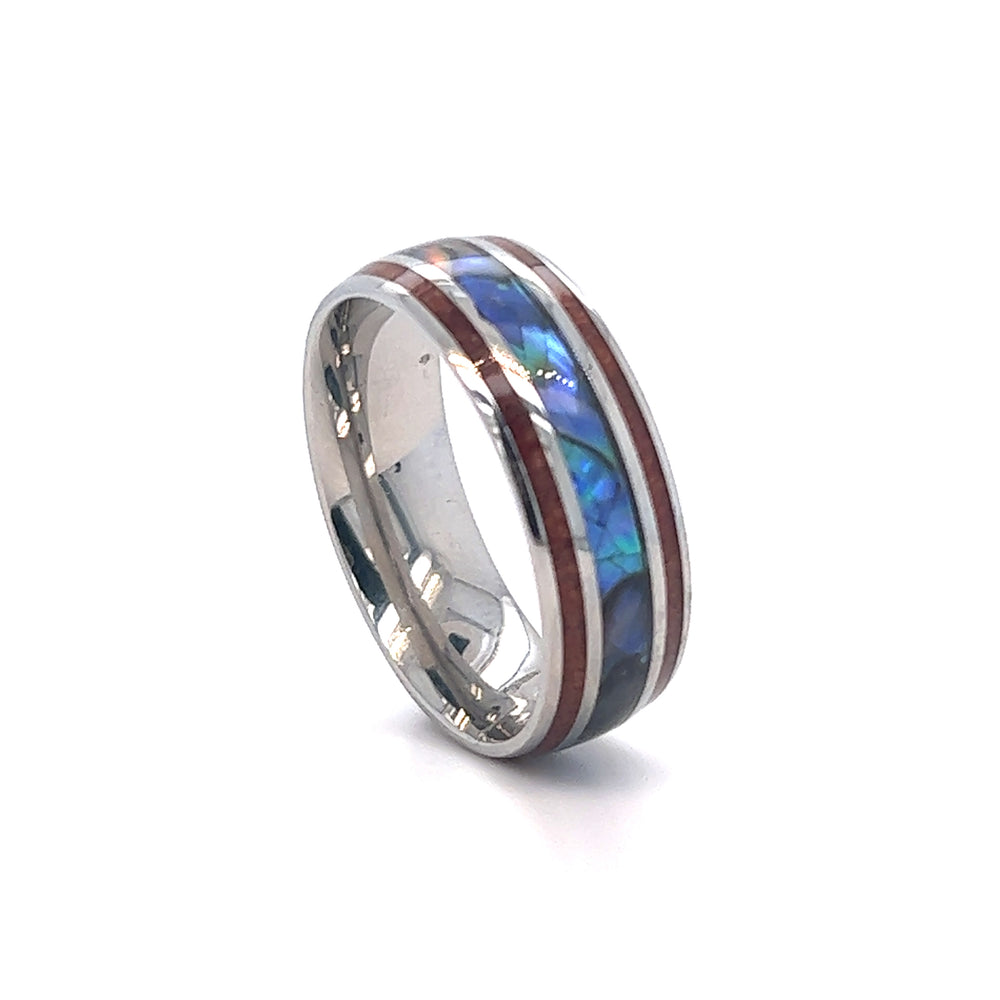 
                  
                    A Super Silver Abalone and Koa Wood Stainless Steel men's wedding ring with a blue and red inlay.
                  
                