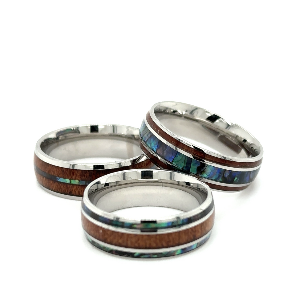 
                  
                    Three Super Silver men's stainless steel Abalone and Koa Wood rings.
                  
                