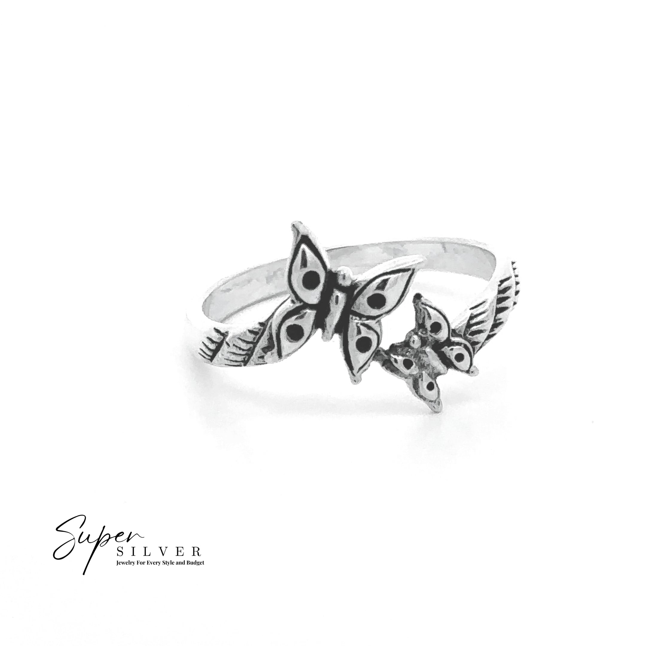 The Dainty Double Butterfly Ring features two butterfly designs—one large and one small—with engraved leaf patterns on the sterling silver band. The "Super Silver" logo appears in the bottom left, making it a true piece of nature-inspired jewelry.