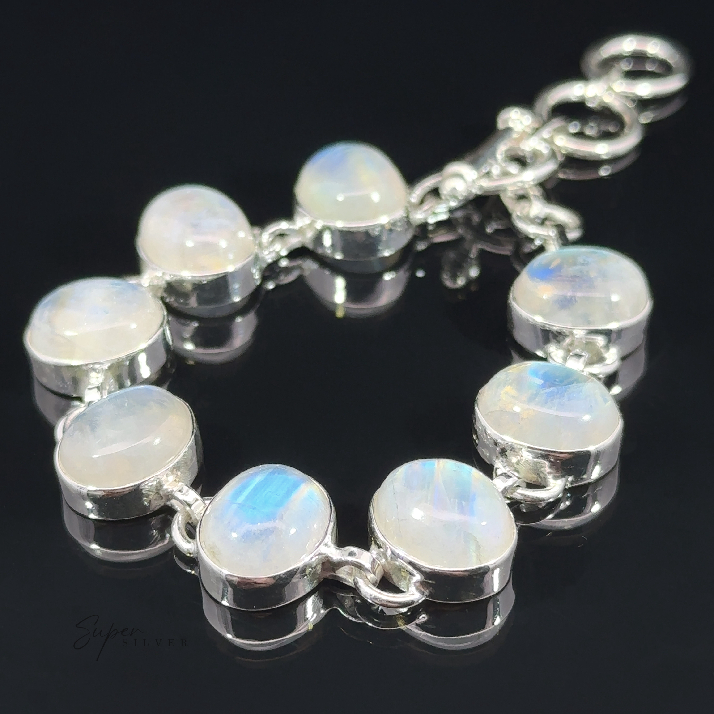 A Statement Oval Gemstone Bracelet featuring round labradorite gems with an iridescent sheen, displayed on a dark background.