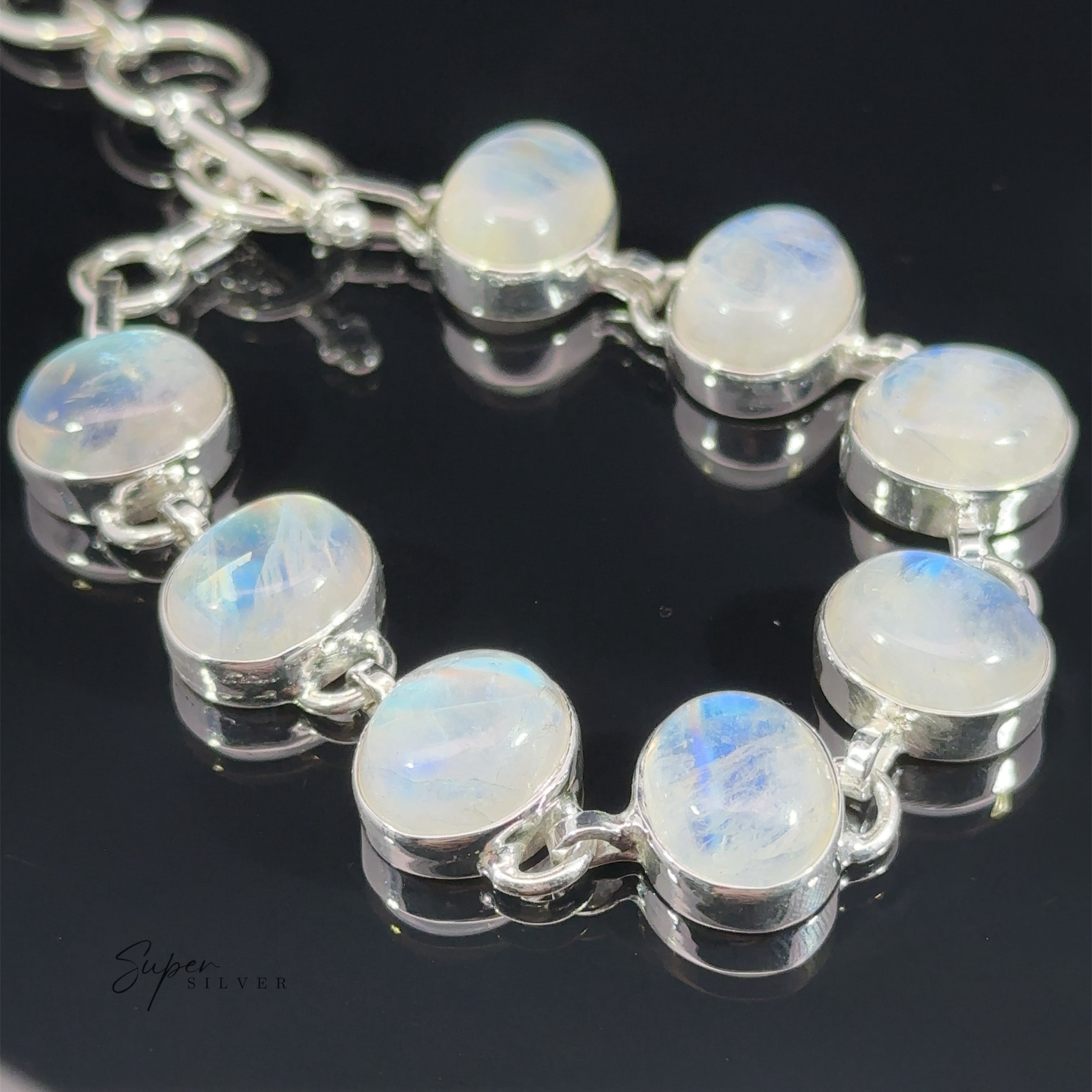 Statement Oval Gemstone Bracelets featuring round opal stones set in a linked gemstone bracelet design, displayed on a dark reflective surface.