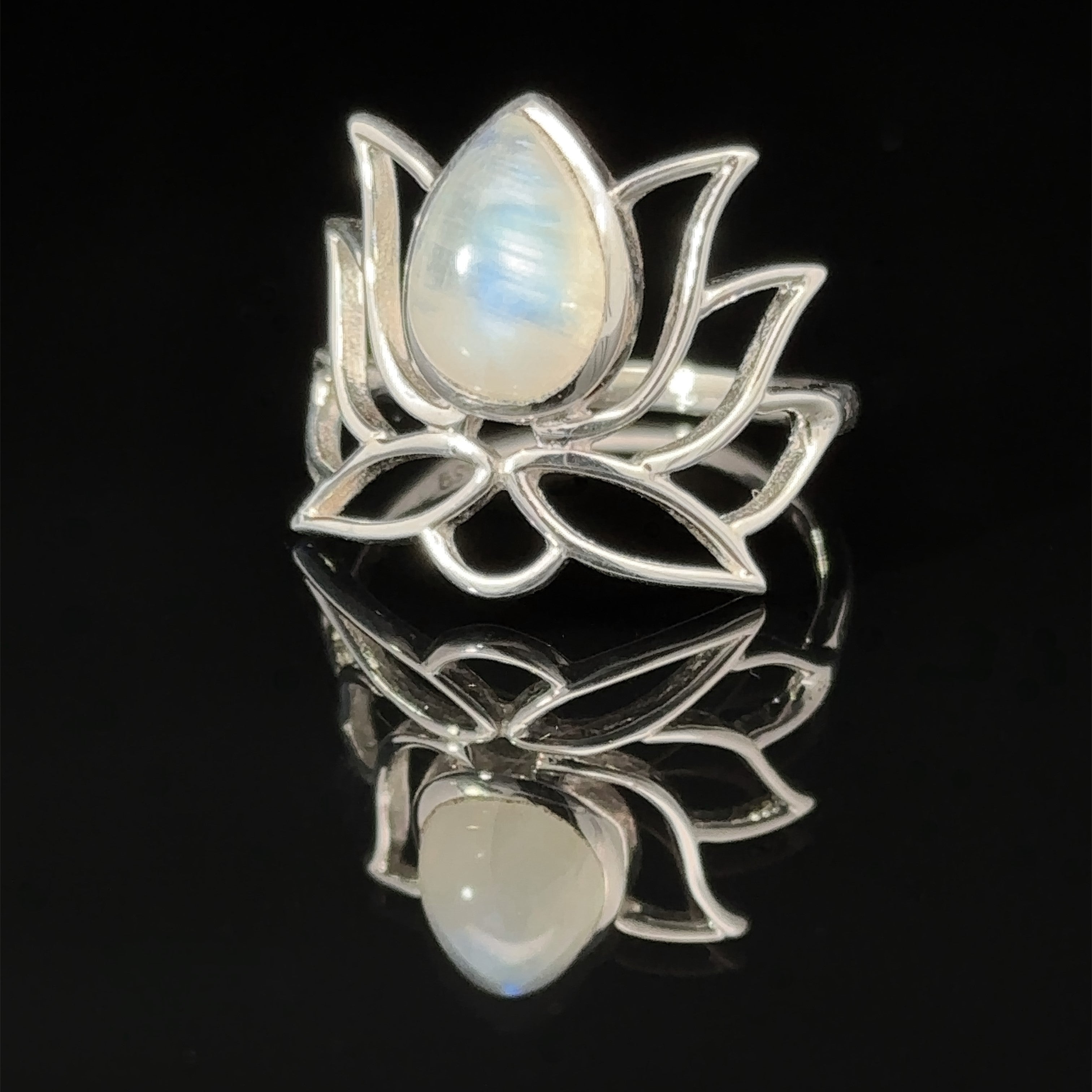 Online Exclusive Teardrop Stone Lotus Ring with a pearlescent teardrop gemstone set in the center, displayed on a reflective black surface.